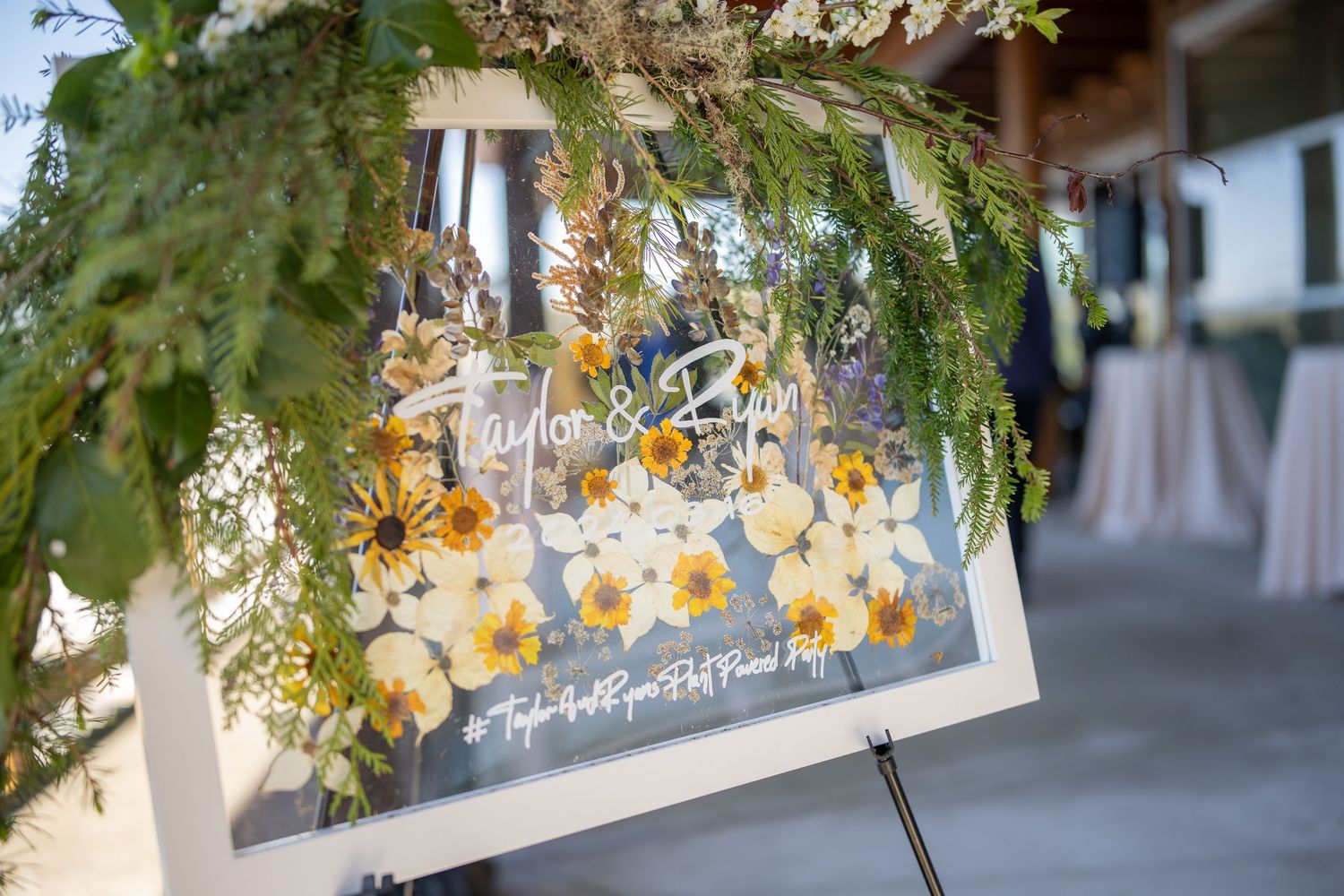Floral decorations with yellow blooms hanging from ceiling.