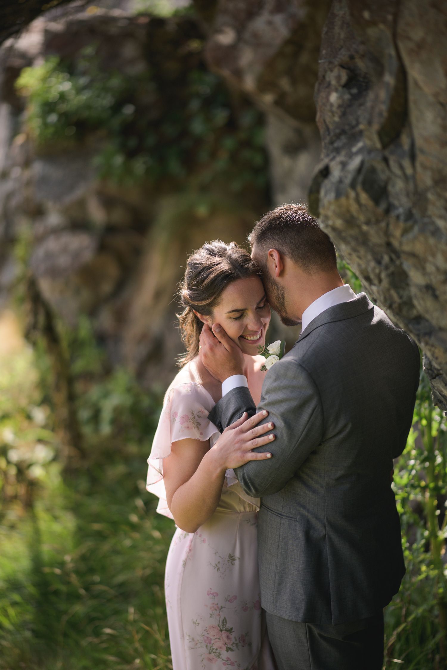 Intimate wedding moment captured between couple in a lush garden setting.