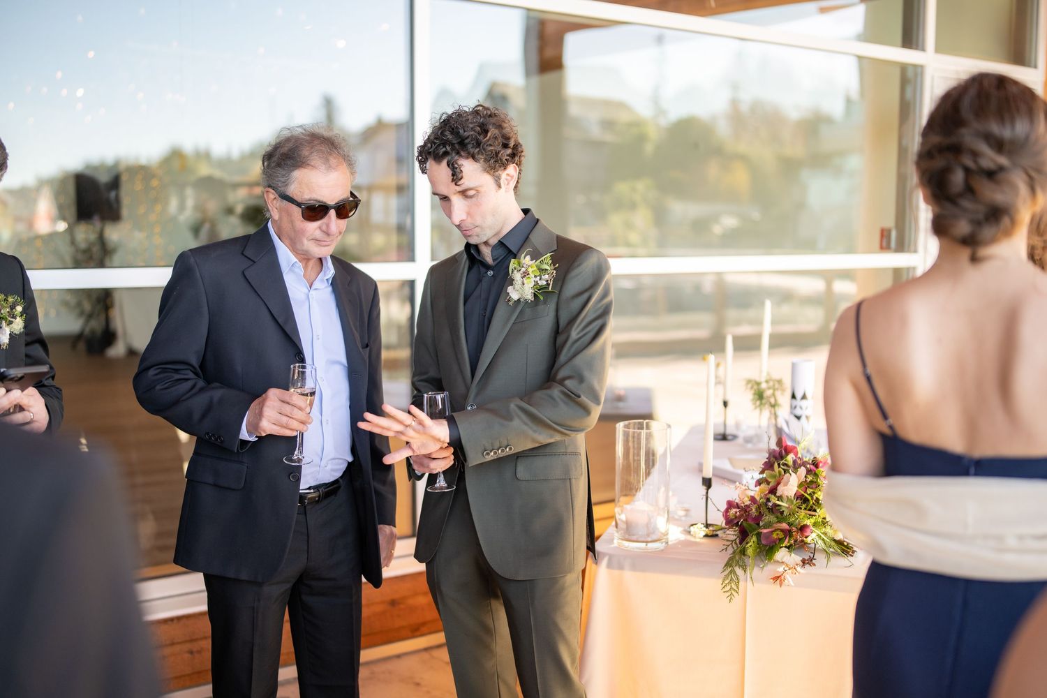 Wedding reception venue features wooden architecture and large windows with natural light.