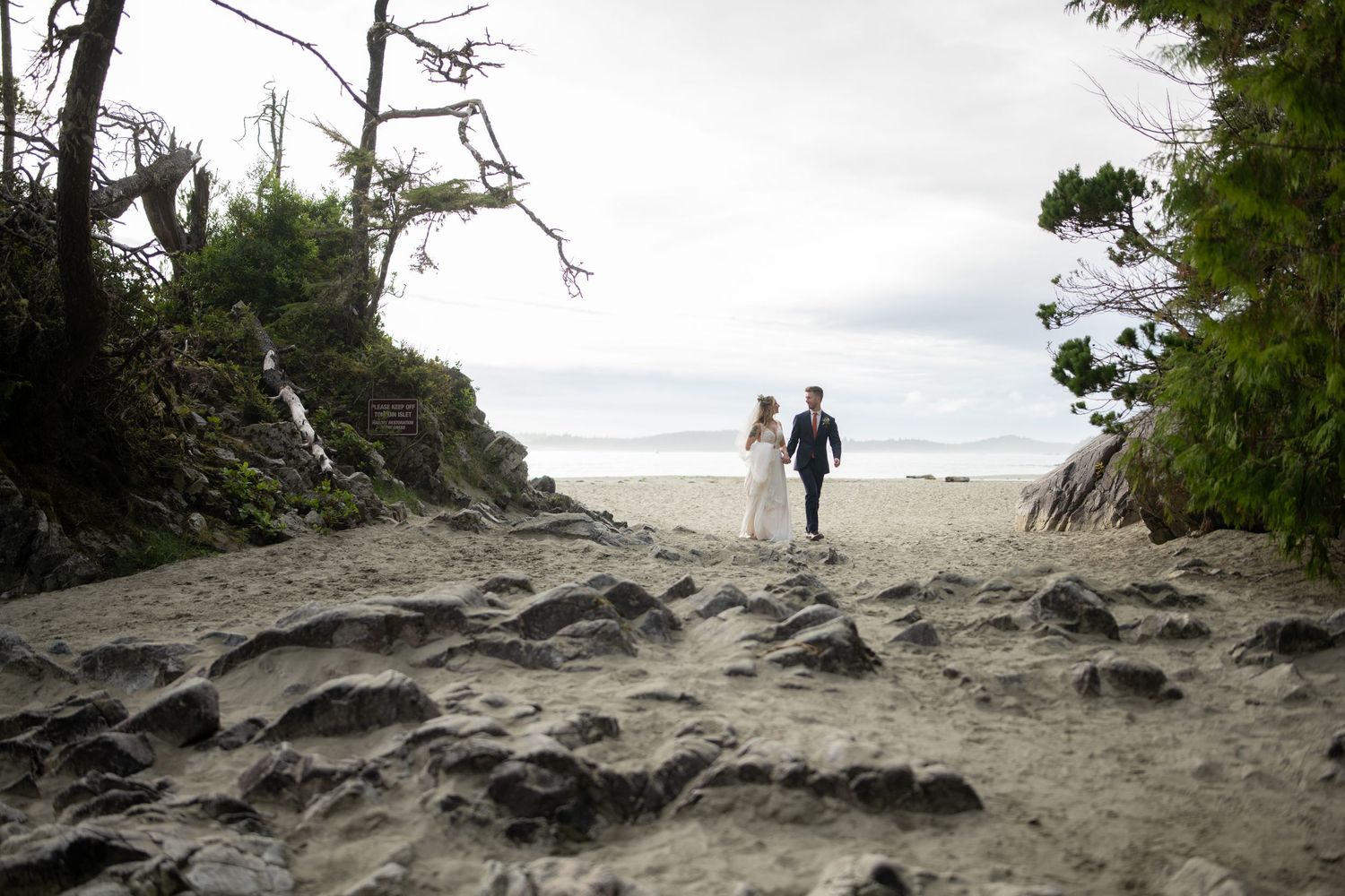 Couple walks along rugged coastal path with dramatic cliffside views.