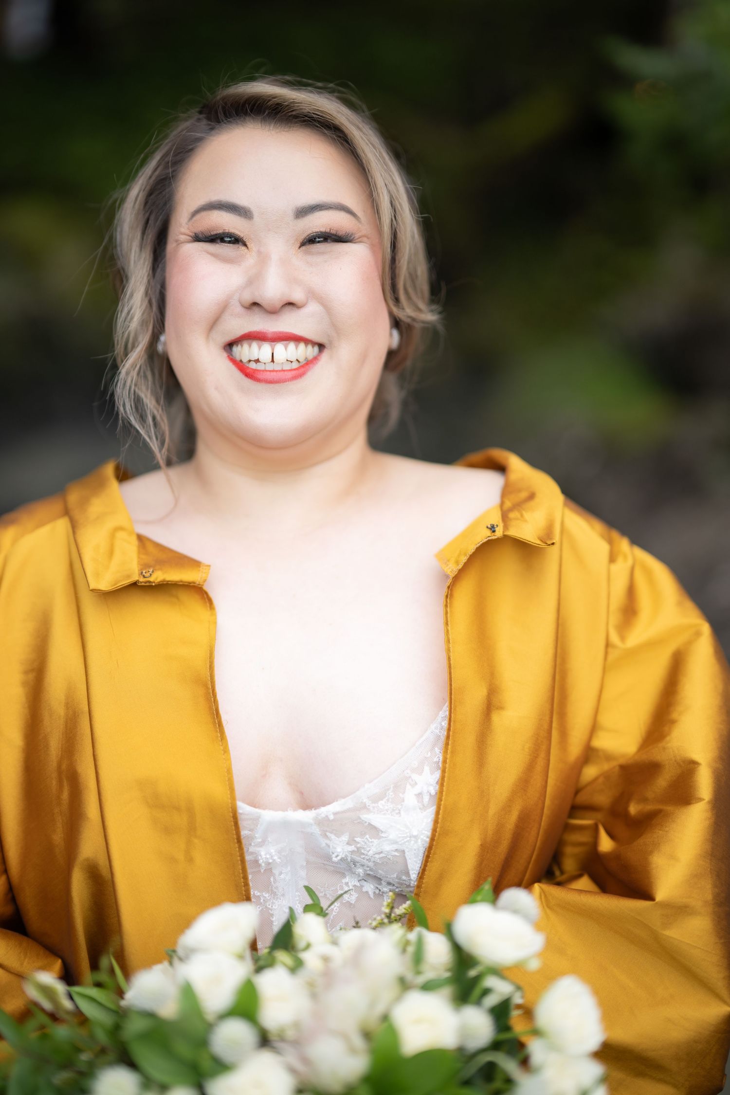 A bright yellow jacket paired with a white dress and floral bouquet.