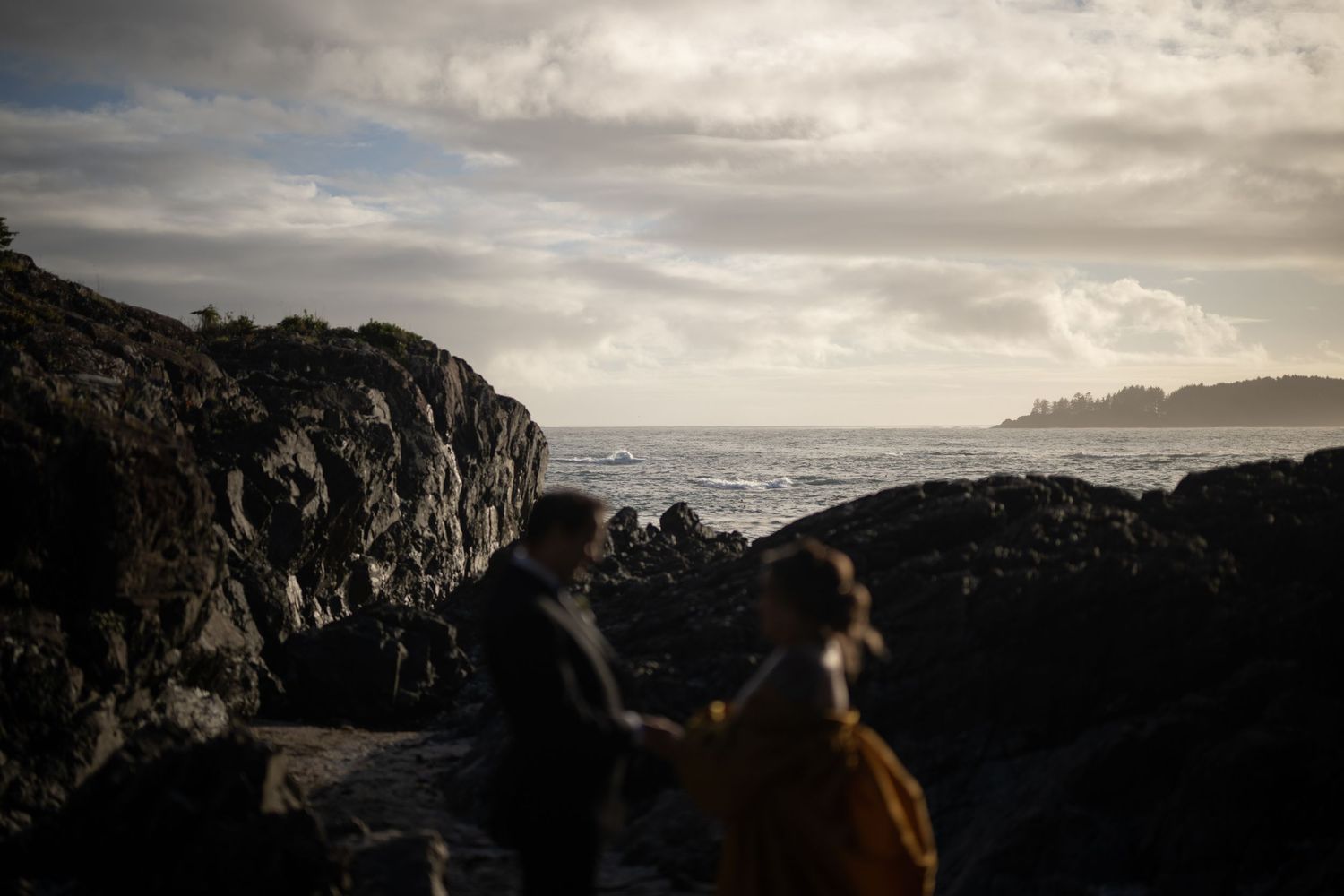 Dramatic cloudy sky over a rocky coastal landscape with ocean views.