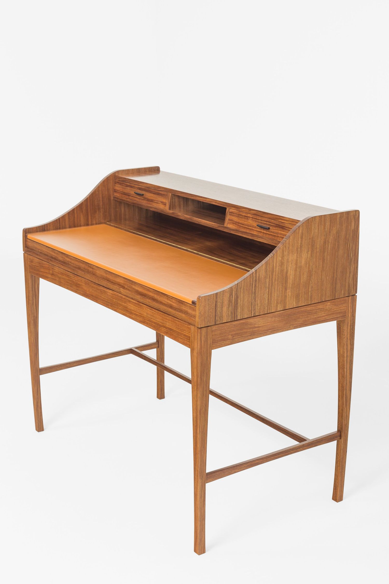 Mid-century modern walnut writing desk with tan leather top, tiered storage compartments and slender tapered legs.