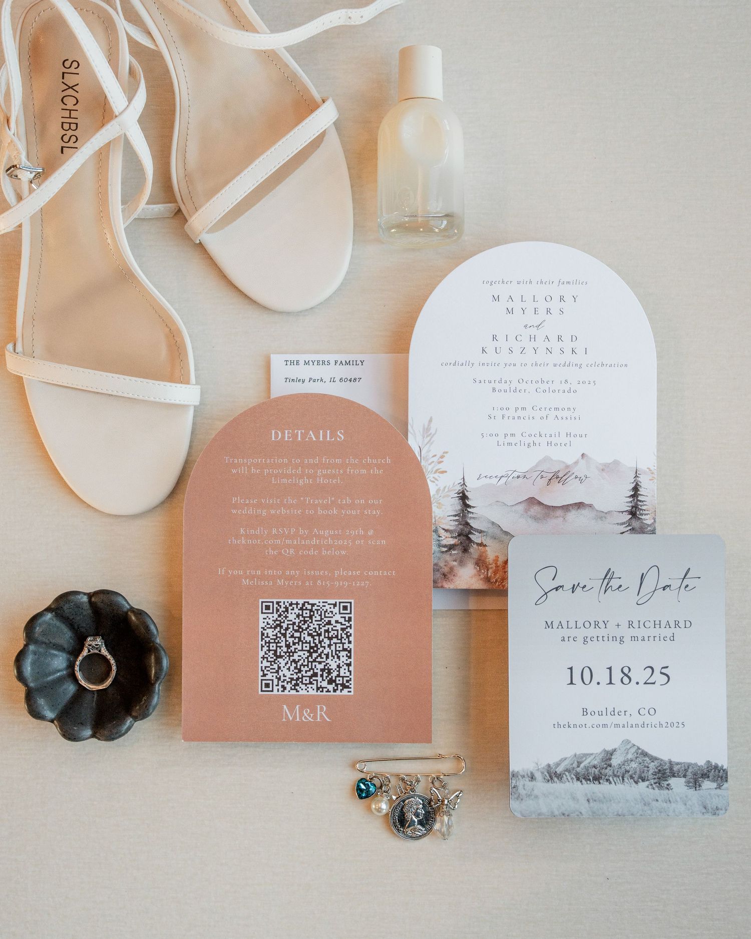 Elegant wedding stationery flatlay with arch invitations, save the date, rings, shoes, and perfume.
