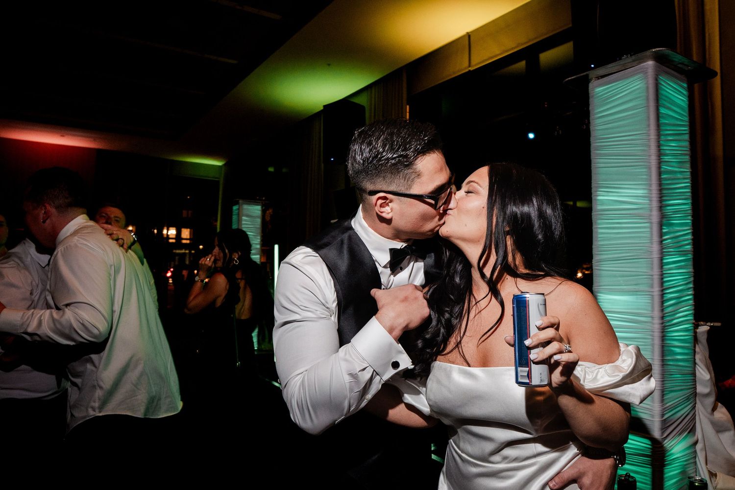 Bride and groom sharing a kiss on the dance floor at their wedding reception.