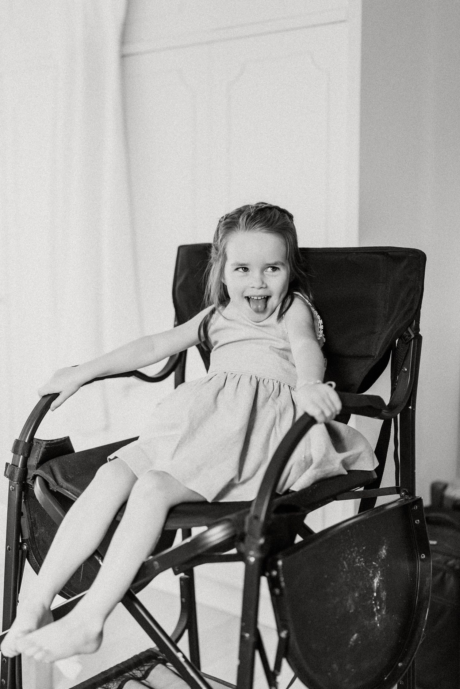 A series of black and white photographs showing a person seated in a chair making different playful poses.