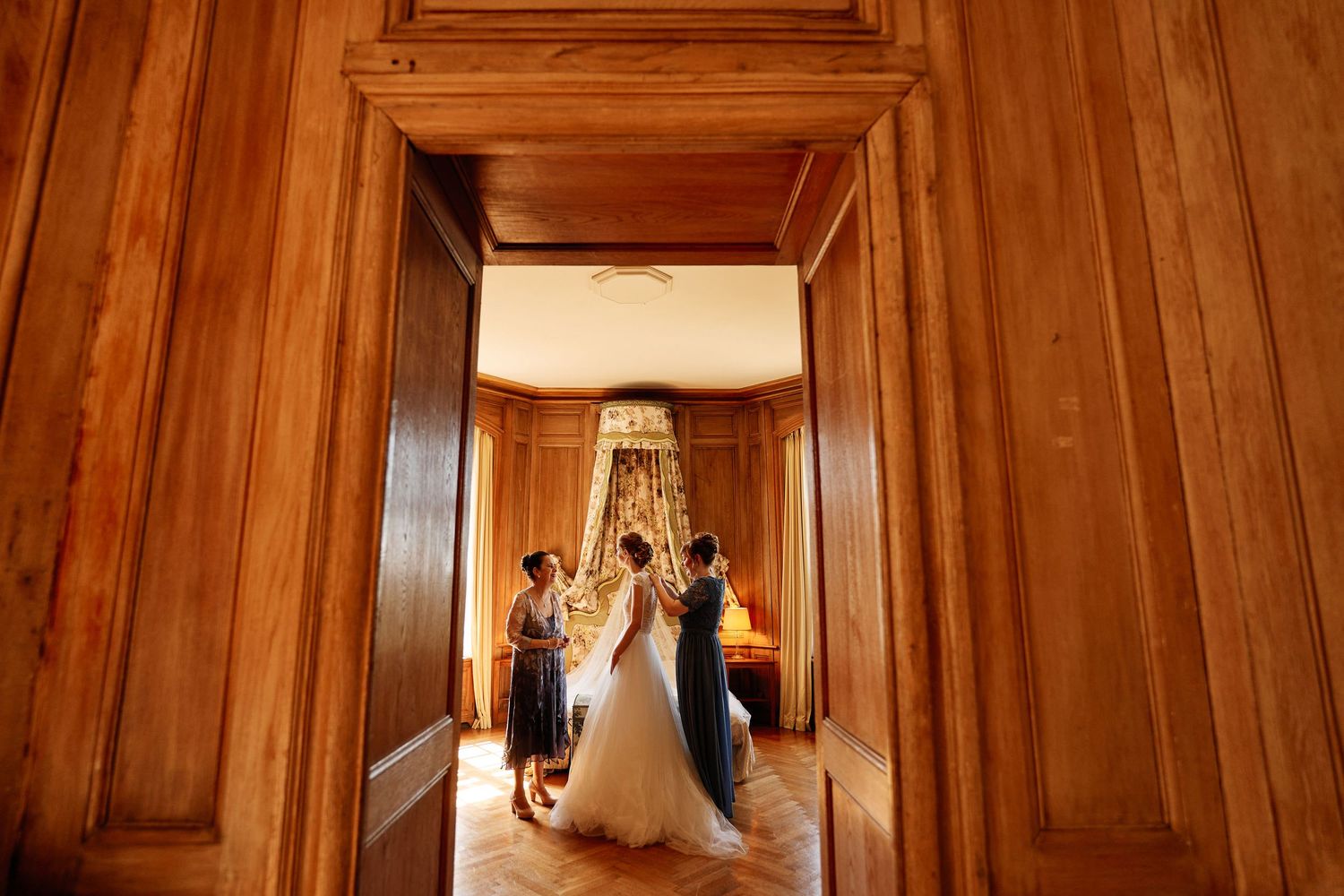 Elegant wood-paneled hallway with natural light streaming through windows creates a warm, luxurious atmosphere.