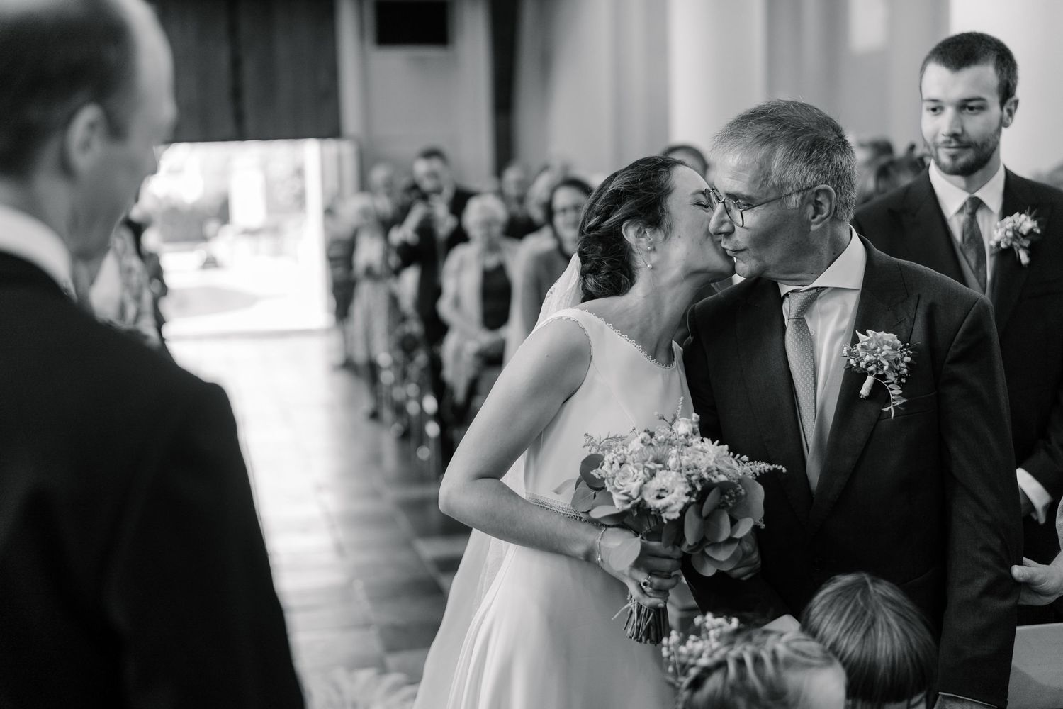Wedding party celebrates with joyful dance moves in an elegant reception venue during special moment.