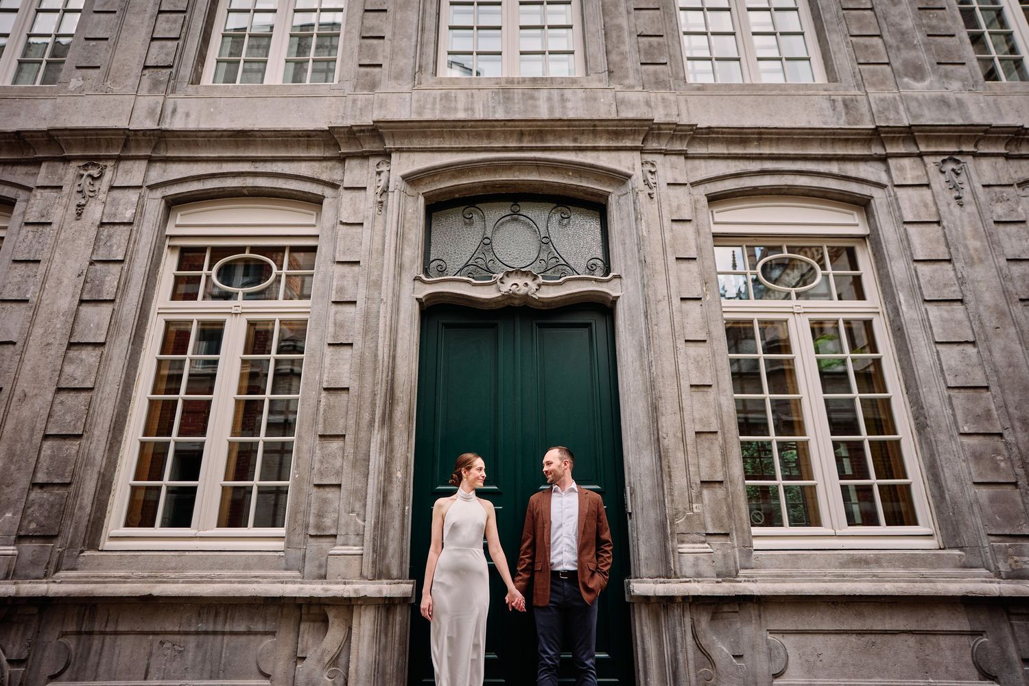 A series of vintage-style wedding photographs showing couples posing in front of a grand stone building with elegant windows.