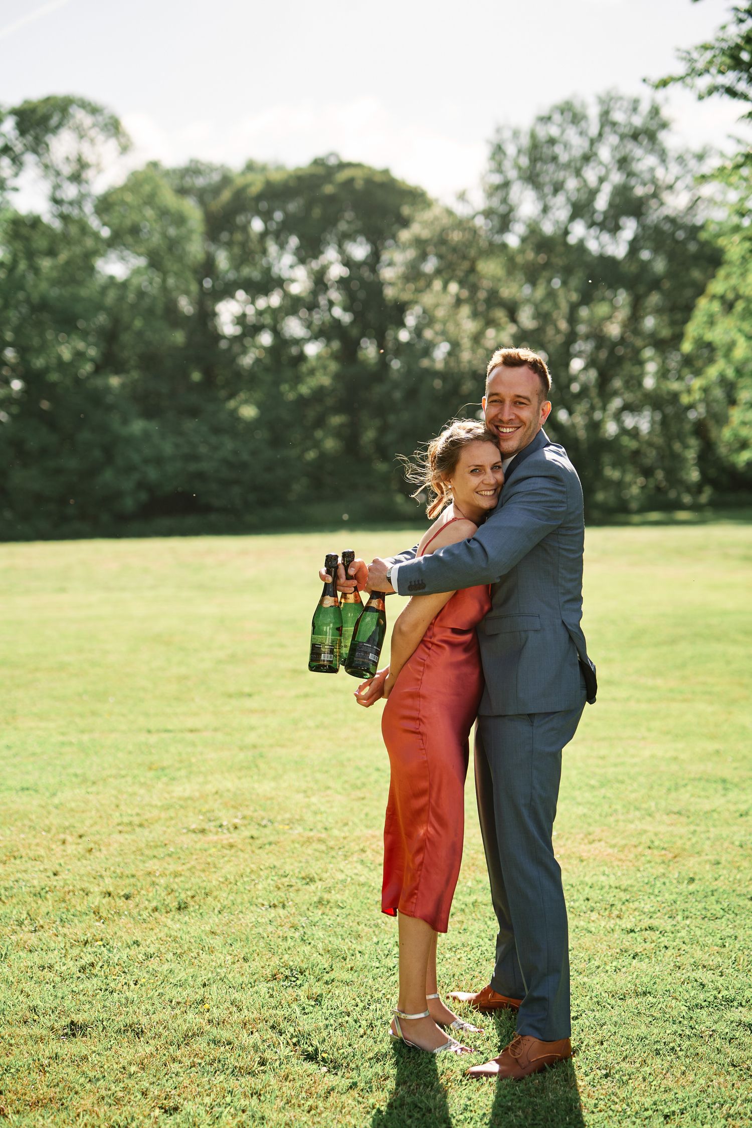 A couple embraces on a sunny green lawn, showing a progression of their joyful hug in multiple frames.