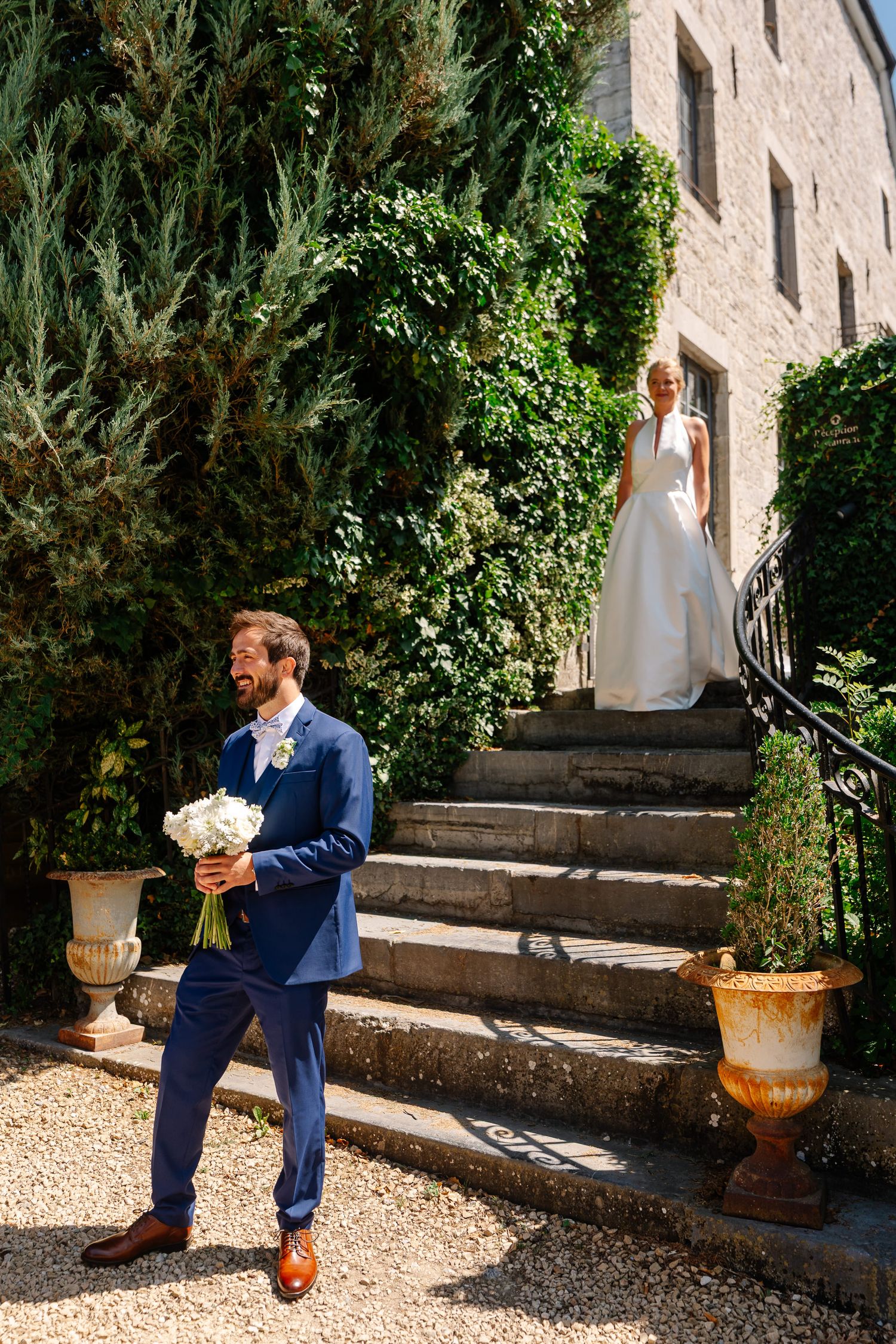 A series of photos showing a person in a navy blue suit sitting on stone steps in a garden courtyard setting.