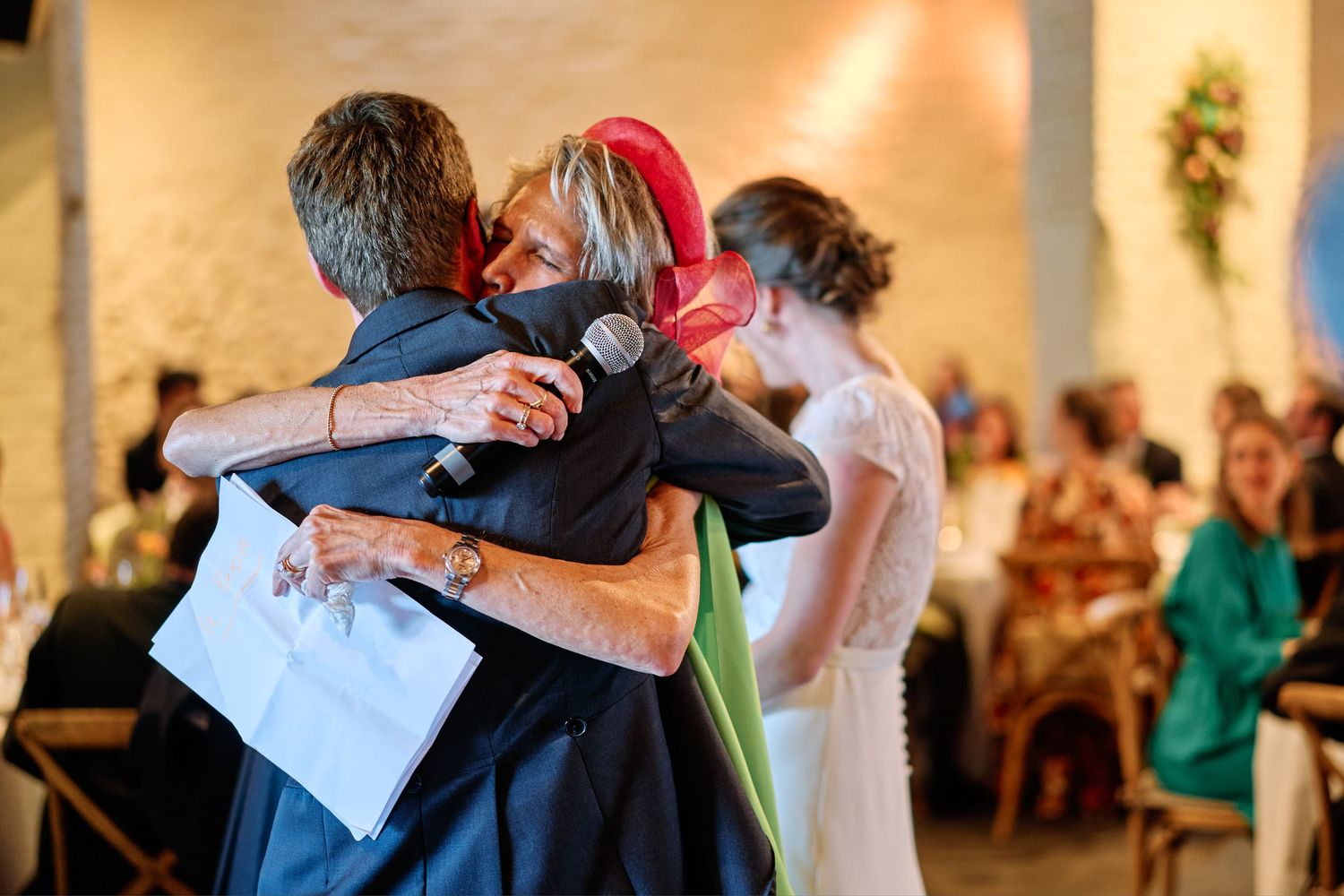 Wedding guests dance and celebrate together on a ballroom dance floor during a reception celebration.