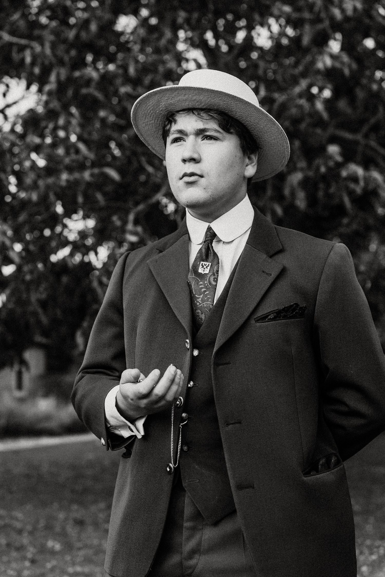 A vintage black and white photo series shows a person in a suit and hat smoking outdoors.