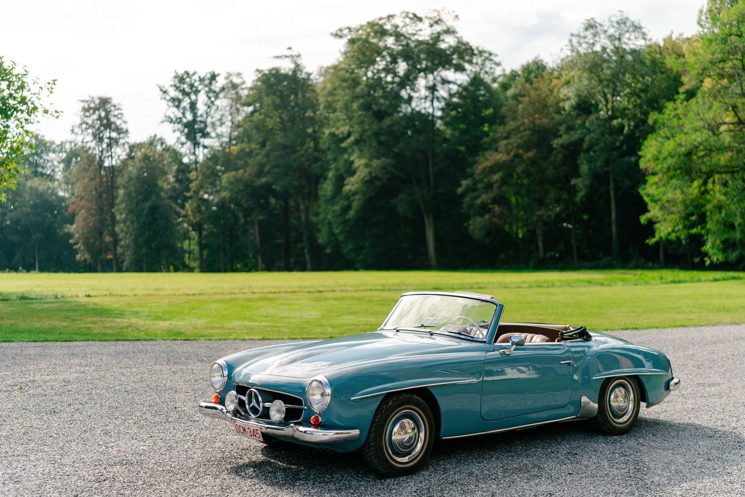 Vintage turquoise Mercedes-Benz convertible car photographed from multiple angles on a scenic golf course.