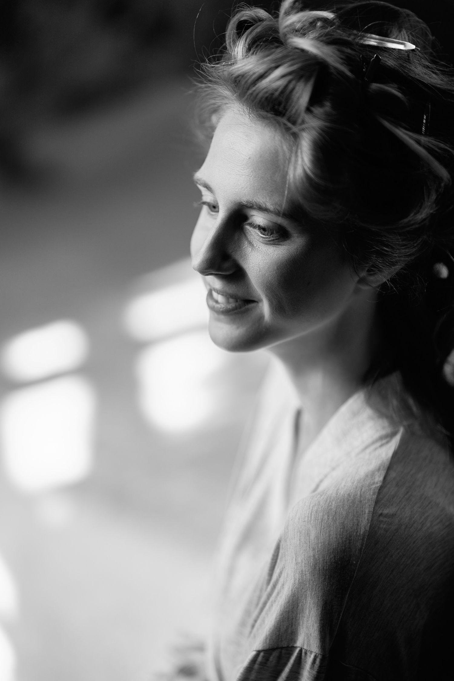 A black and white portrait series showing a woman's profile with soft lighting and gentle expressions.