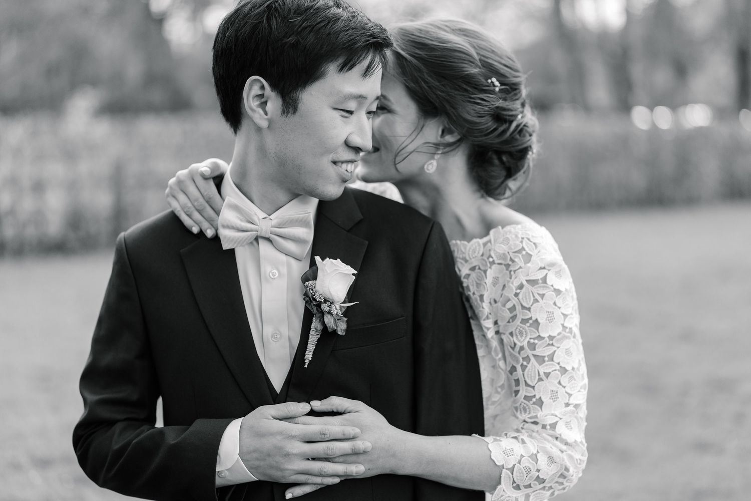 A romantic black and white photo series of a couple sharing tender moments in a garden setting.