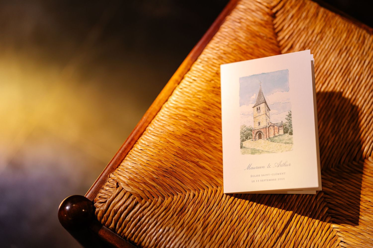 A row of vintage postcards displayed on a textured wooden surface with dramatic lighting and shadows.