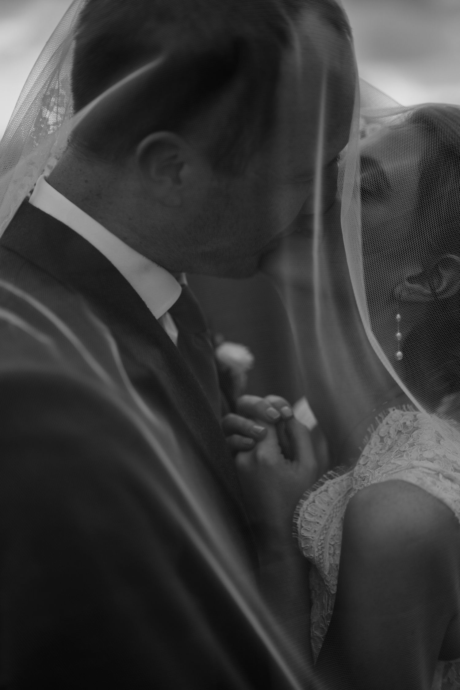 Black and white sequence of romantic wedding kiss photos showing tender moments between newlyweds.