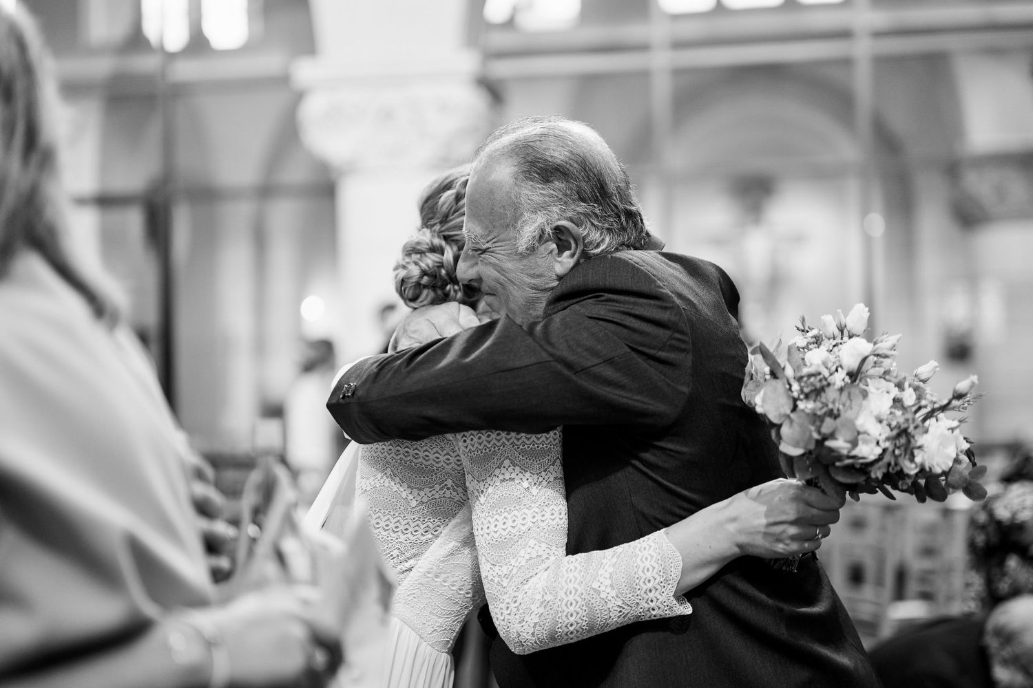 A black and white photo montage showing tender moments between couples embracing at what appears to be a wedding.
