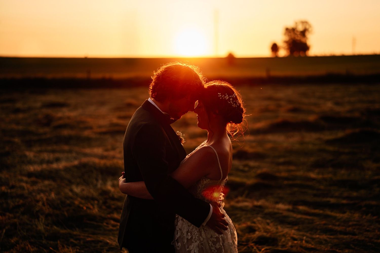 Silhouettes against golden sunset sky creating romantic atmosphere.