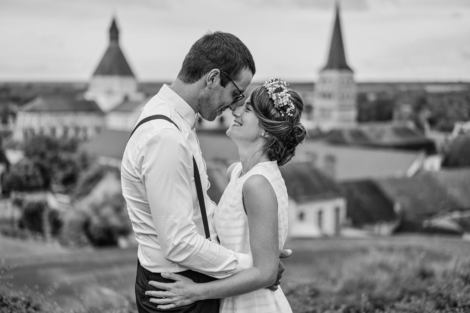 Black and white wedding photographs showing romantic moments between couples in outdoor settings.