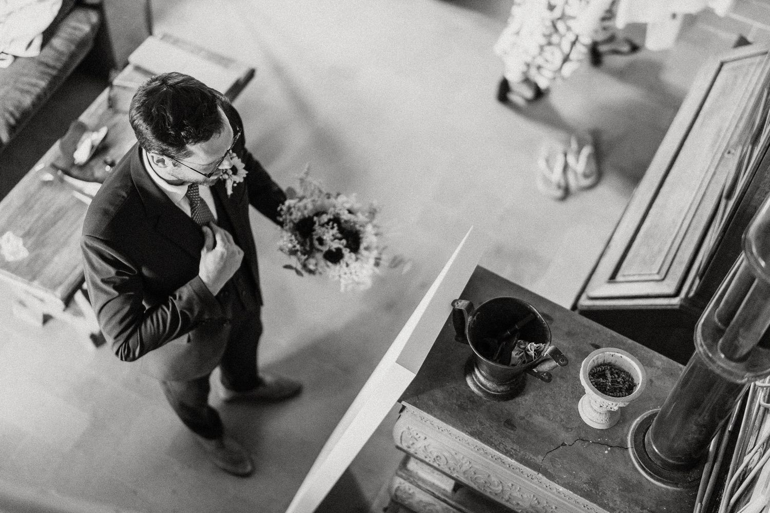 Black and white photo series showing a toddler exploring and playing with various objects on the floor.