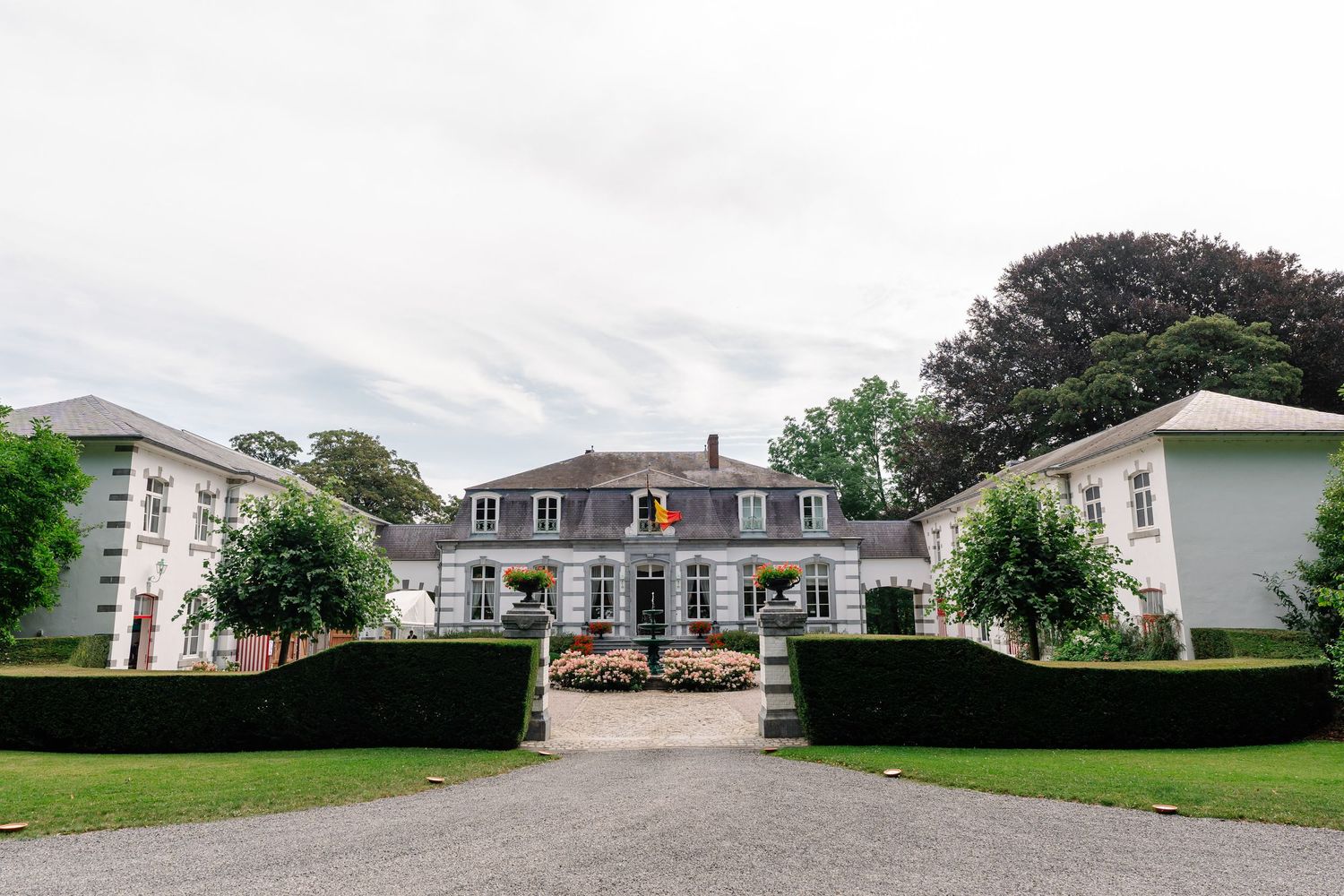 Panoramic view of suburban homes and well-maintained lawns along a residential street in a peaceful neighborhood setting.