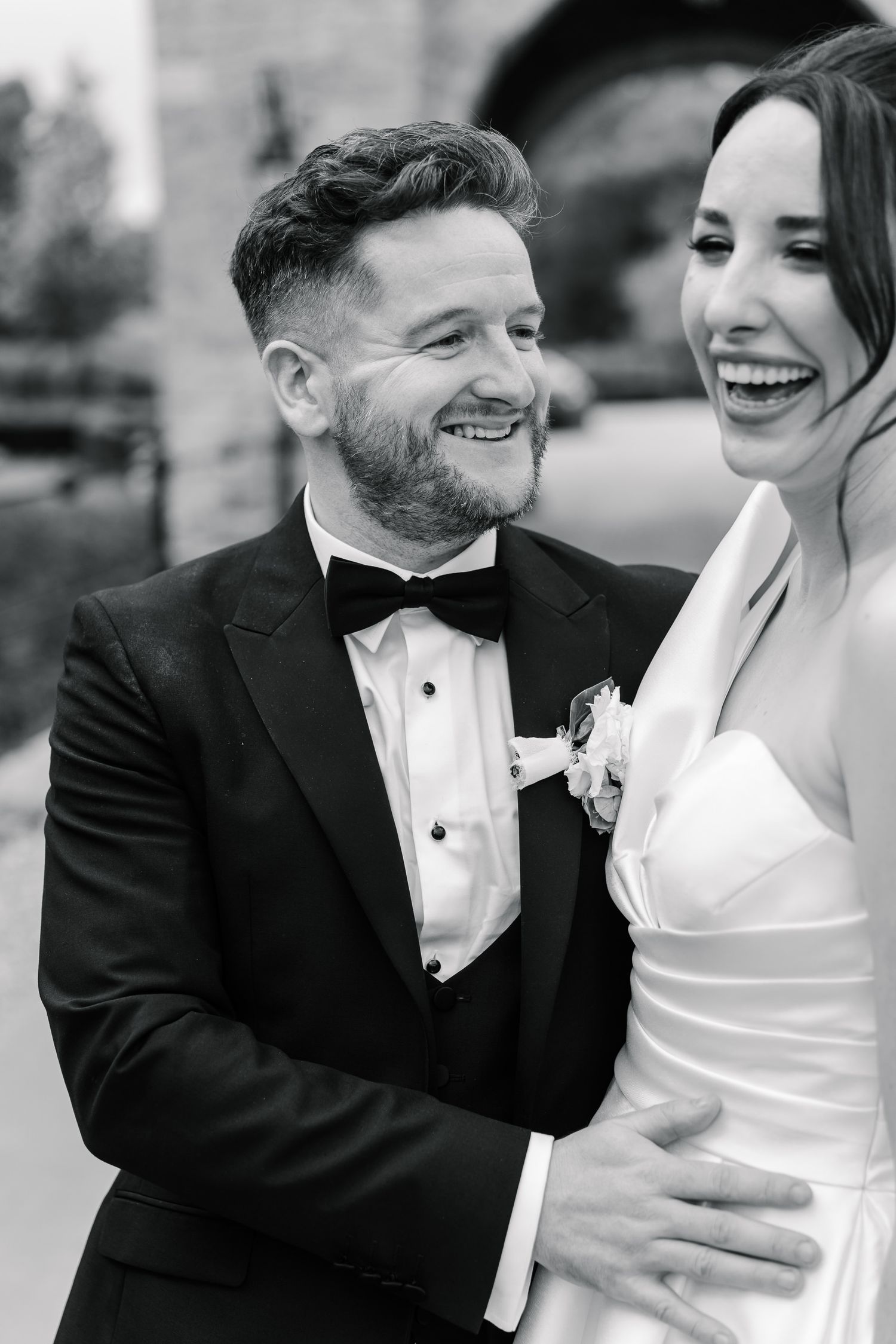 Black and white wedding photo sequence showing couple sharing joyful laughter and intimate moments together.
