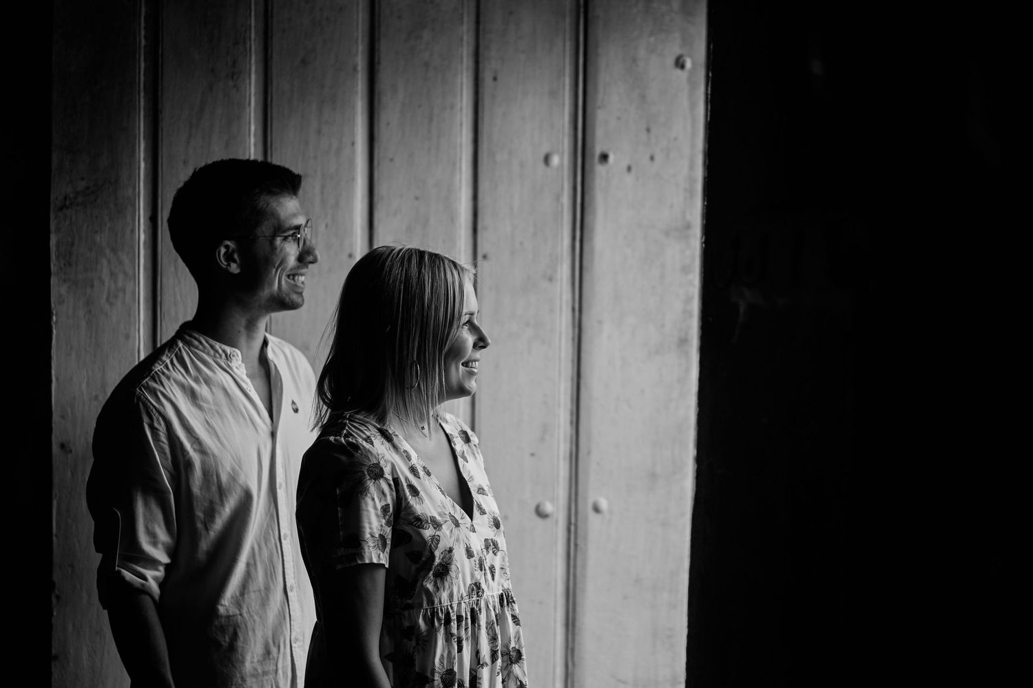 Black and white photo series showing a couple in silhouette against a light background with wooden panels.