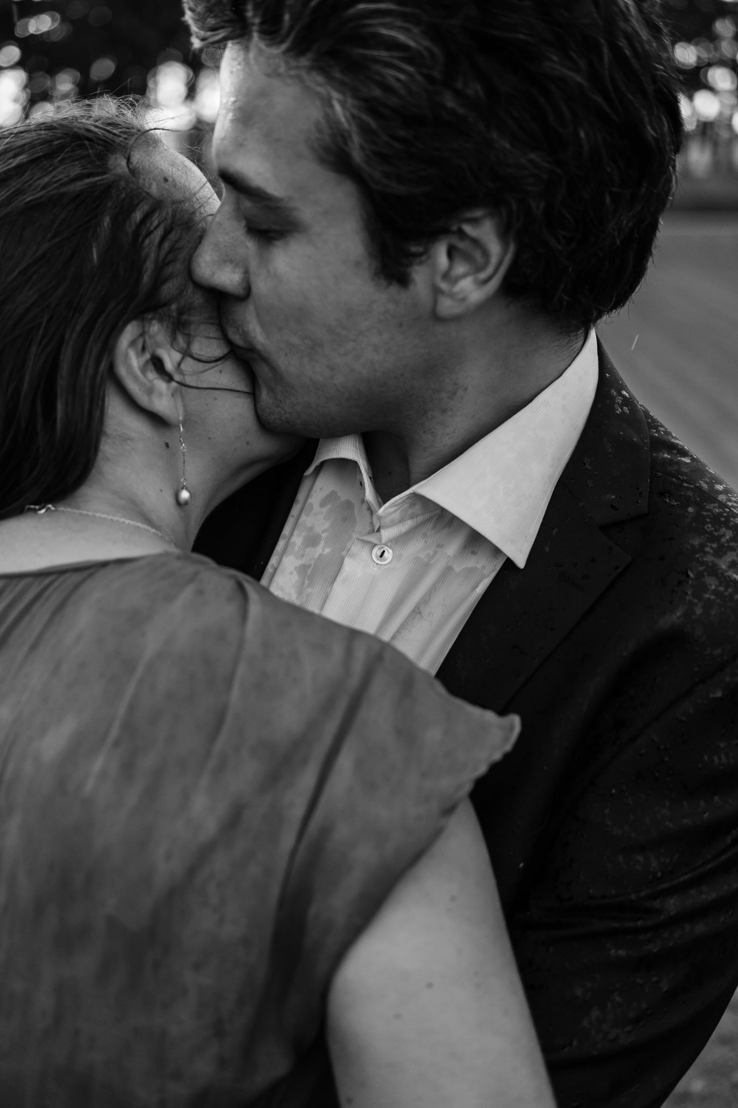 A romantic black and white photo sequence showing a couple sharing an intimate kiss.