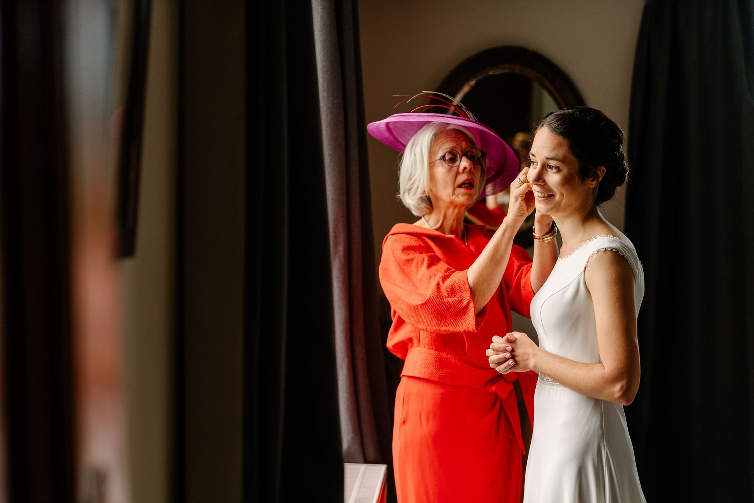 Two people share an intimate dance moment during a wedding celebration in formal attire.