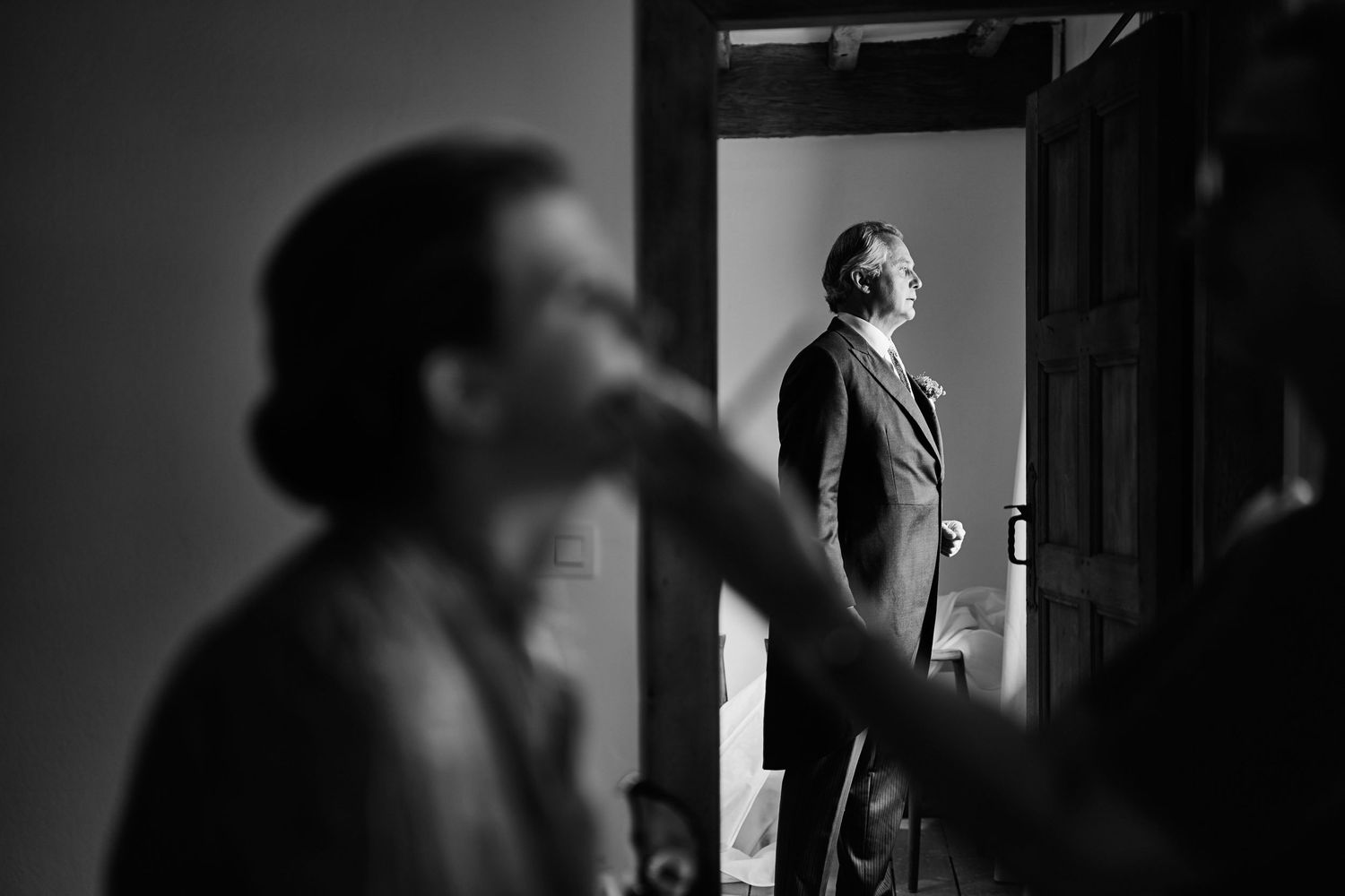 A dramatic black and white film noir style photo sequence showing silhouettes of figures in doorways and dark spaces.