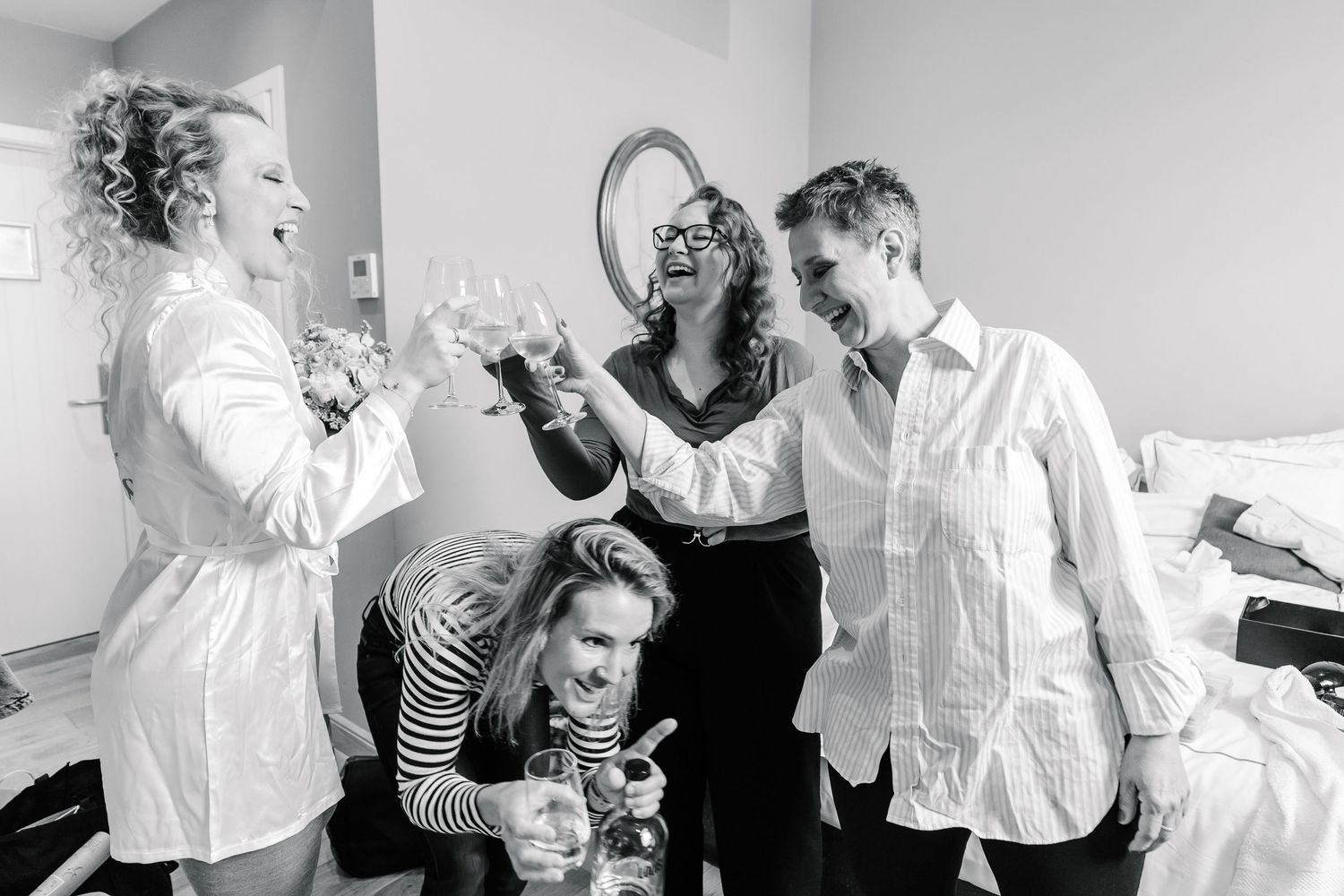 A sequence of black and white photographs showing people dancing and celebrating at a joyful social gathering.
