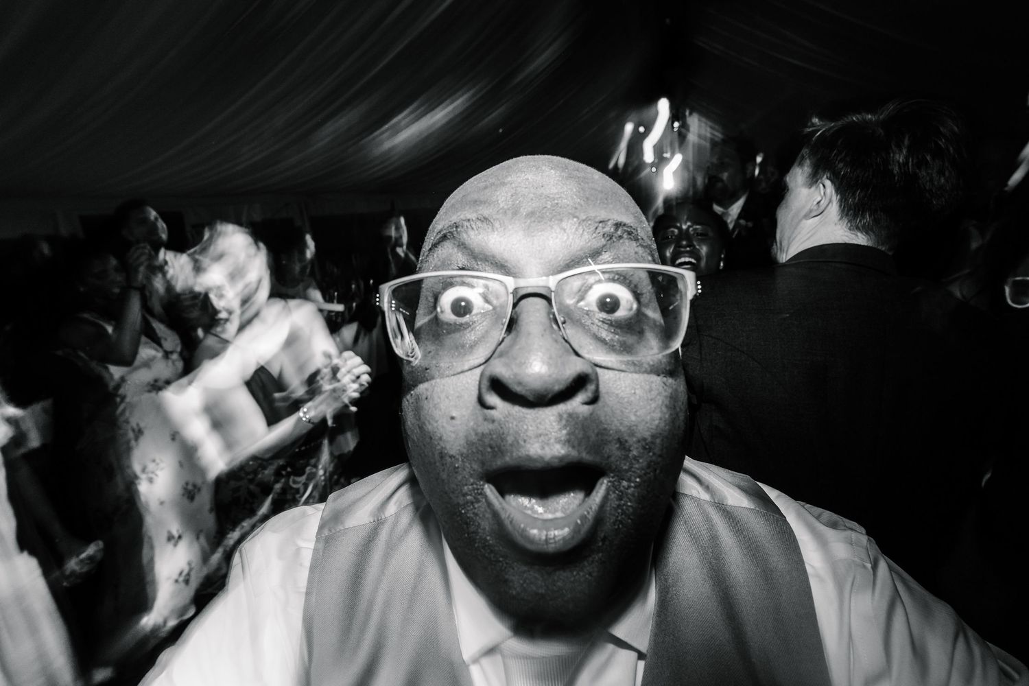 A series of black and white close-up portraits showing various emotional expressions in a film strip style layout.