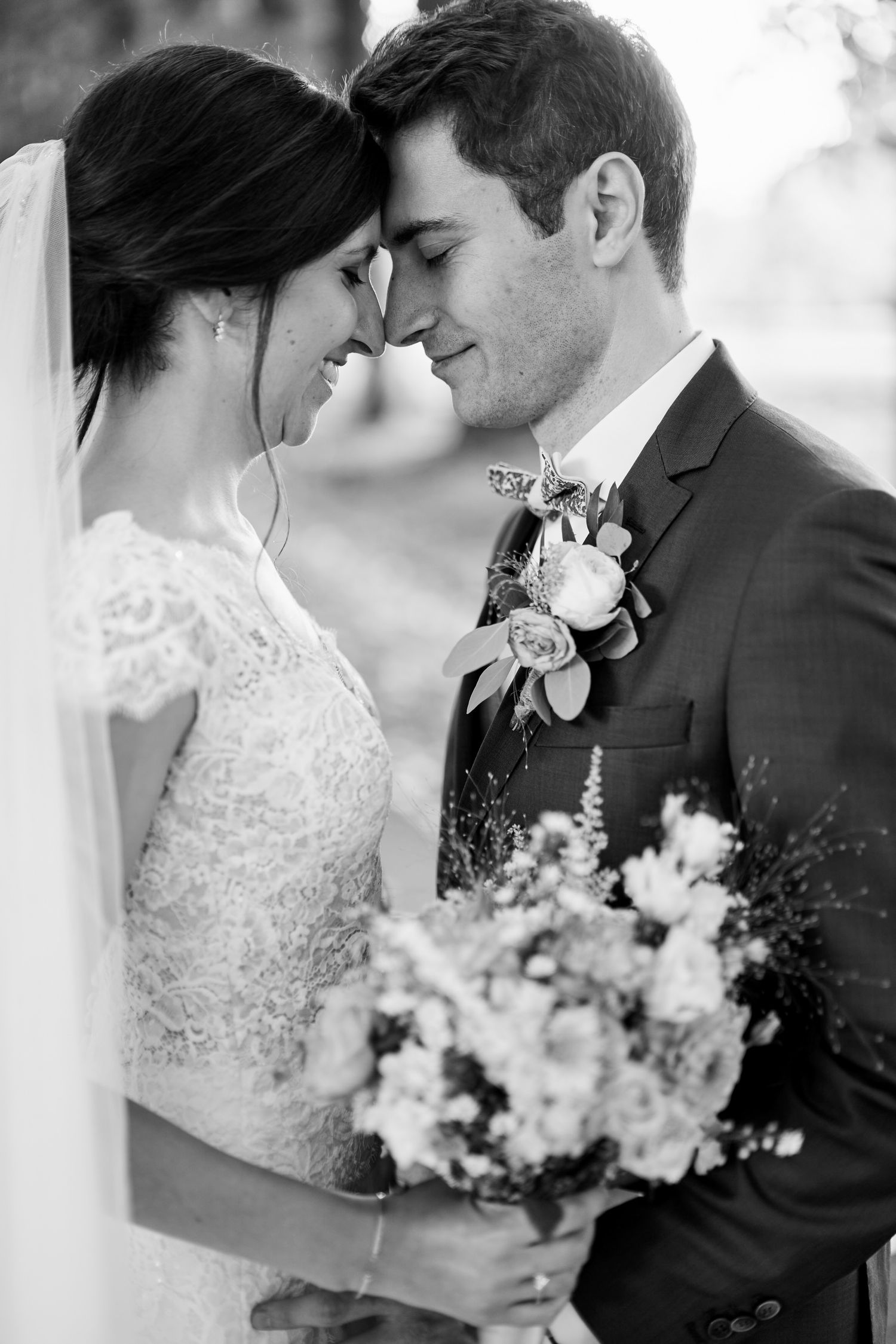 A romantic black and white wedding photo collage showing tender moments between a bride and groom with floral bouquet.