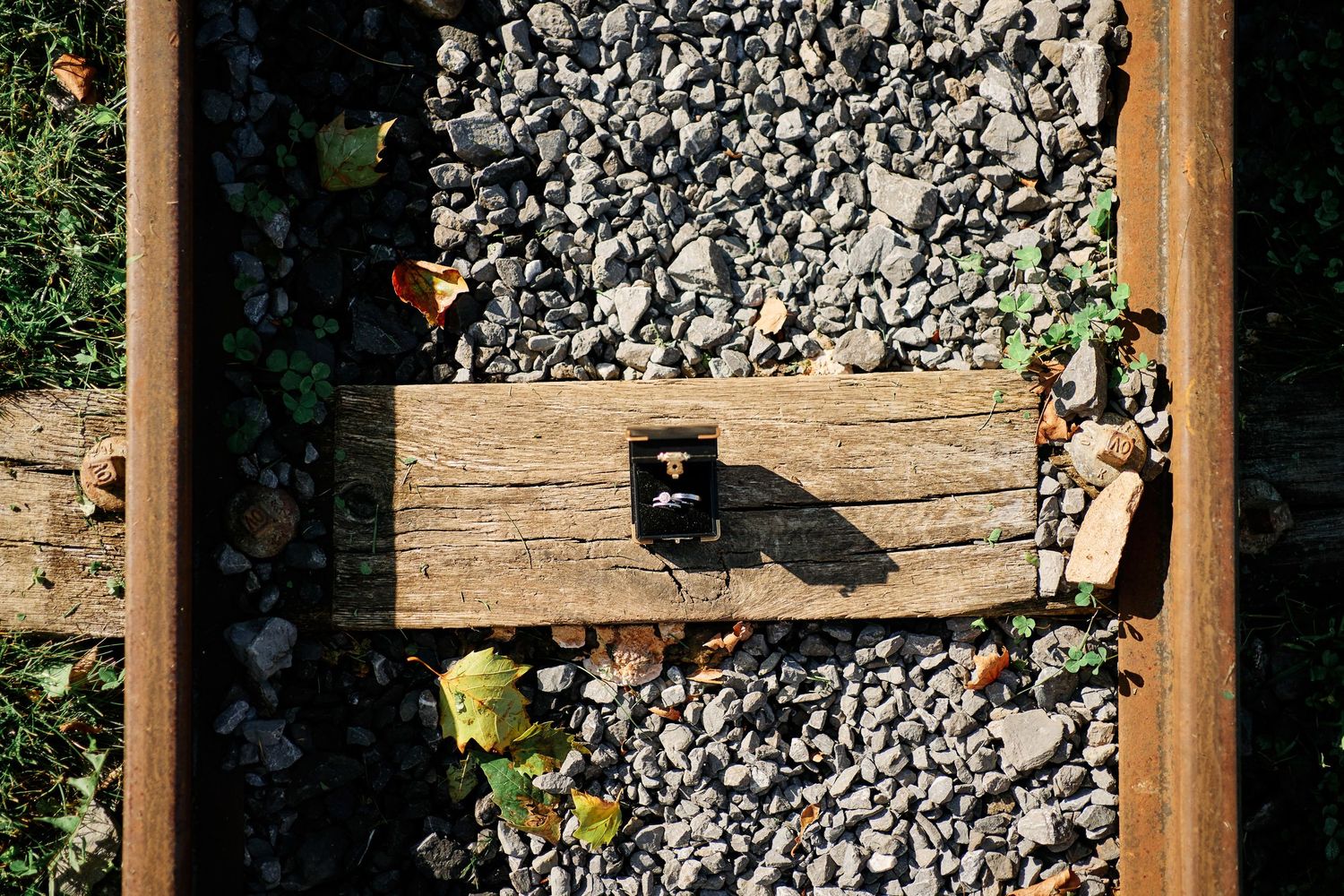 A close-up view of gravel and wooden posts creating a rustic garden border or landscaping feature.