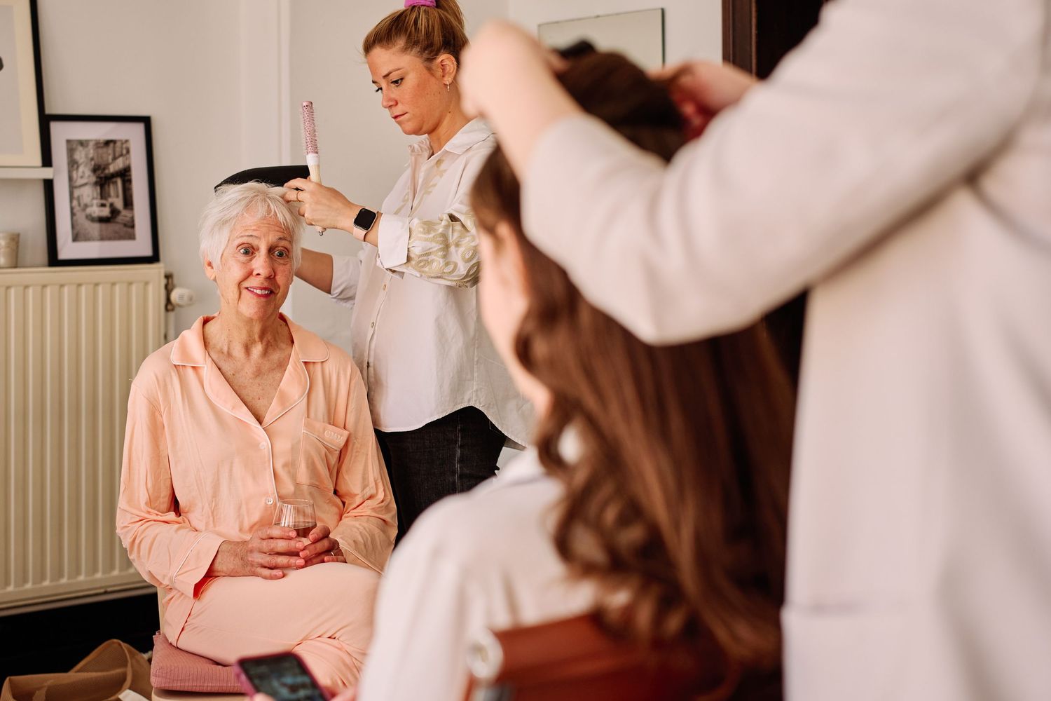 Healthcare professional discussing treatment options with elderly patient wearing pink sweater during medical consultation.