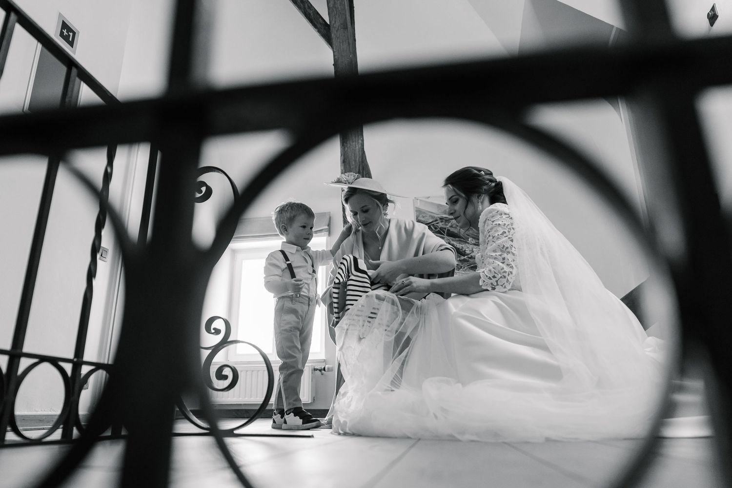 A black and white artistic panoramic collage of wedding moments showing rings, flowers, and intimate details.