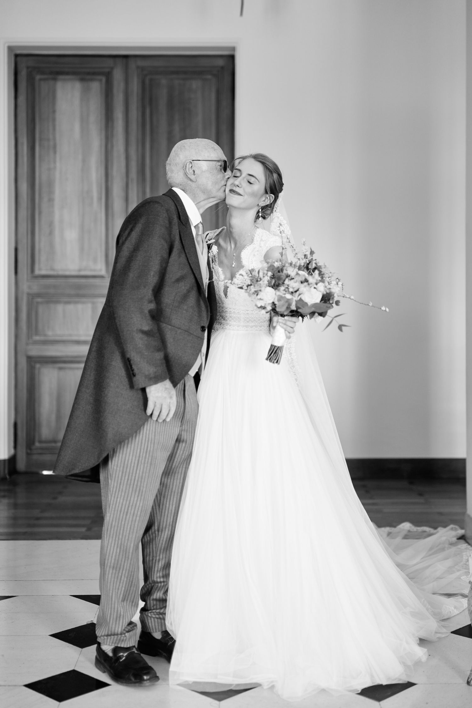 Black and white sequence of four wedding photos showing playful dance moves between a bride and groom on a checkered floor.