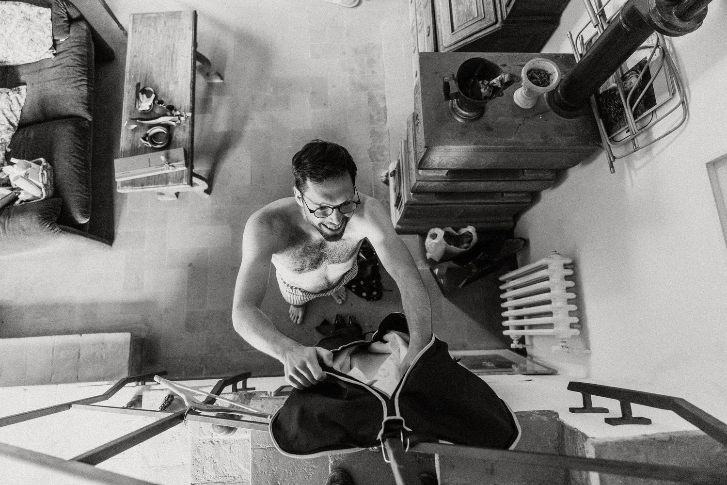 A series of black and white photographs showing someone working on a woodworking project in a workshop.