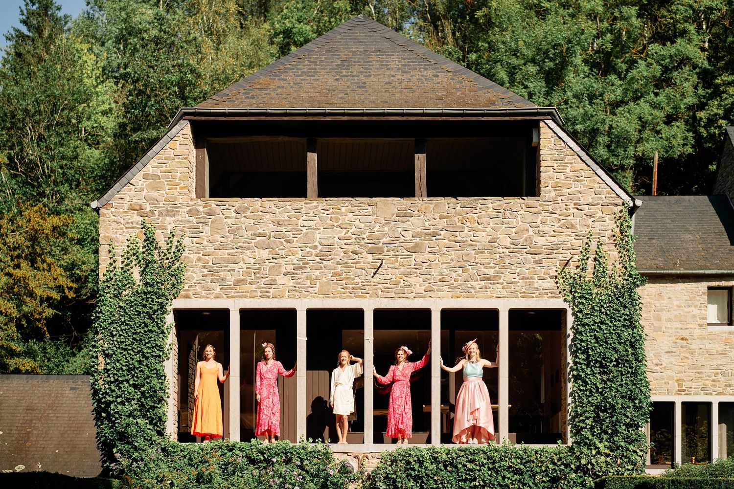 A series of connected images showing people in pink clothing posing in a rustic wooden porch setting.