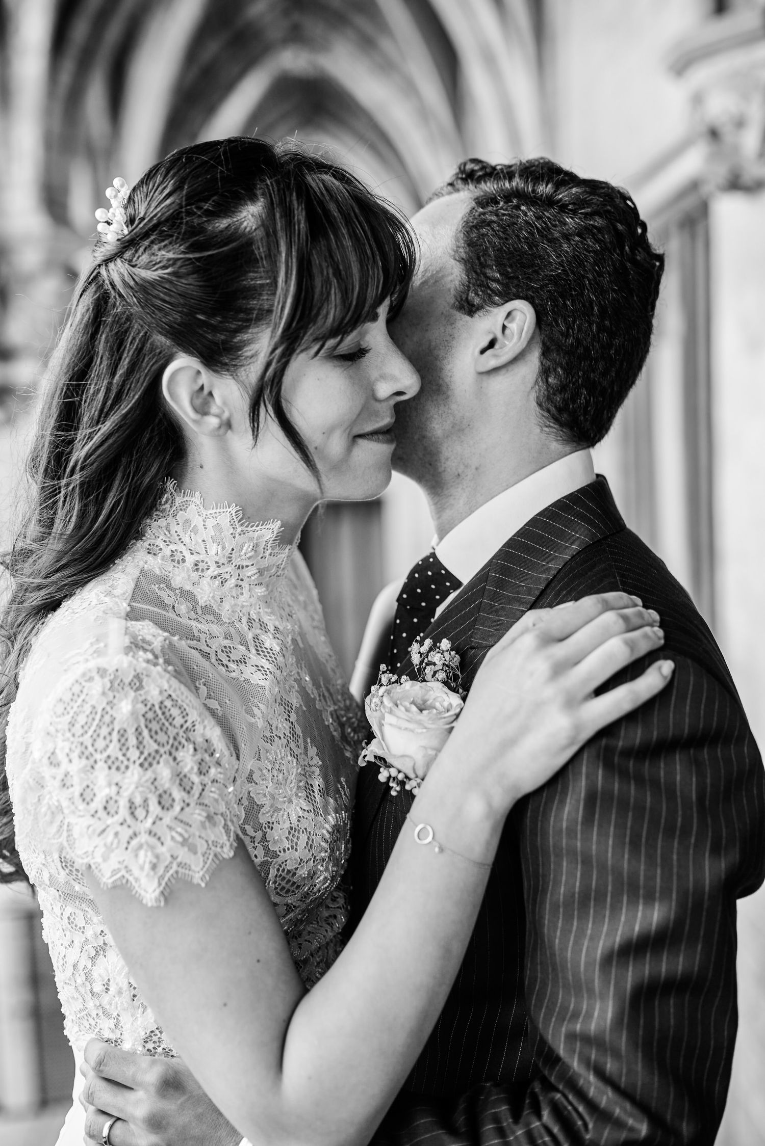 A romantic series of wedding photos showing tender kisses between a bride in lace and groom in pinstripes.