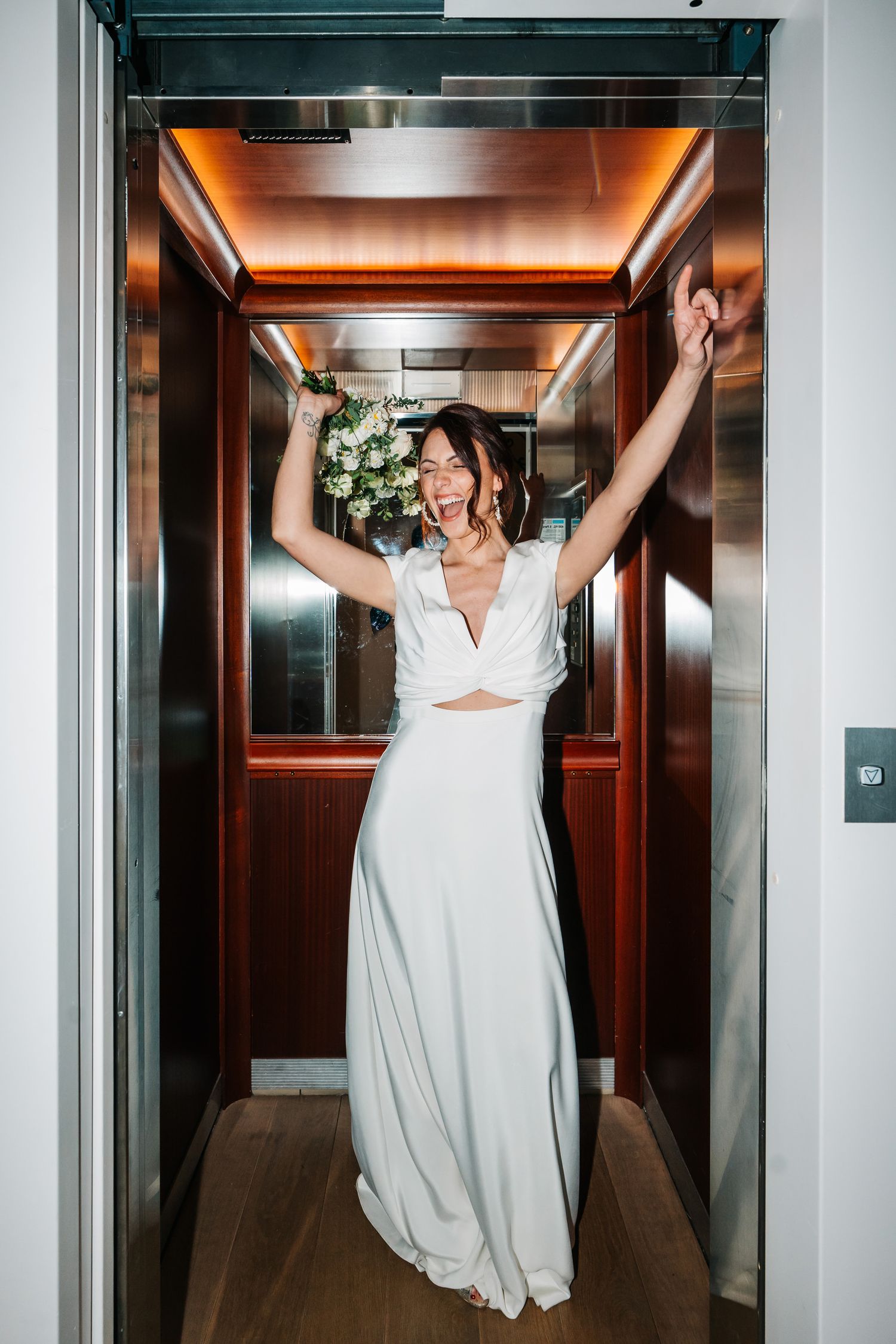 Three sequential photos show someone in a white wedding dress playfully posing inside a modern elevator.