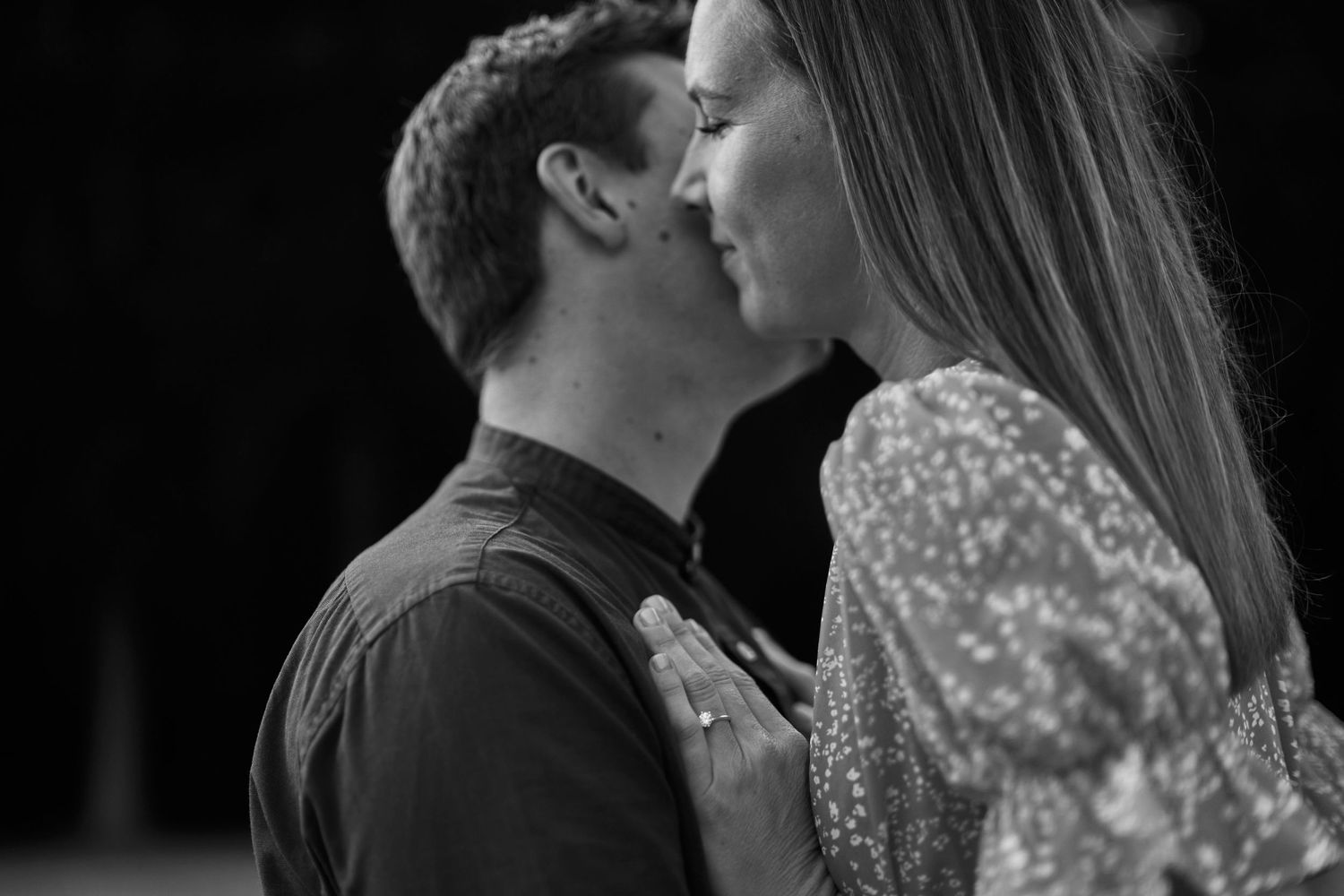 A romantic black and white photo series showing intimate moments between a couple on their wedding day.