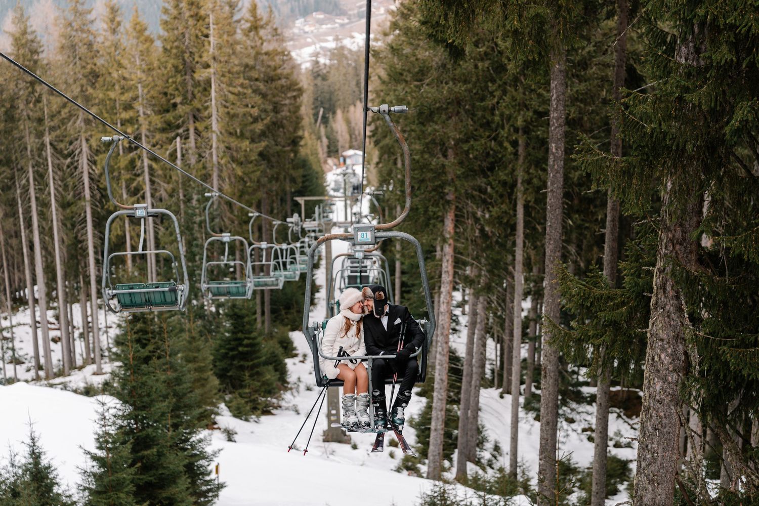 Snow-covered mountain trail through evergreen forest in winter.