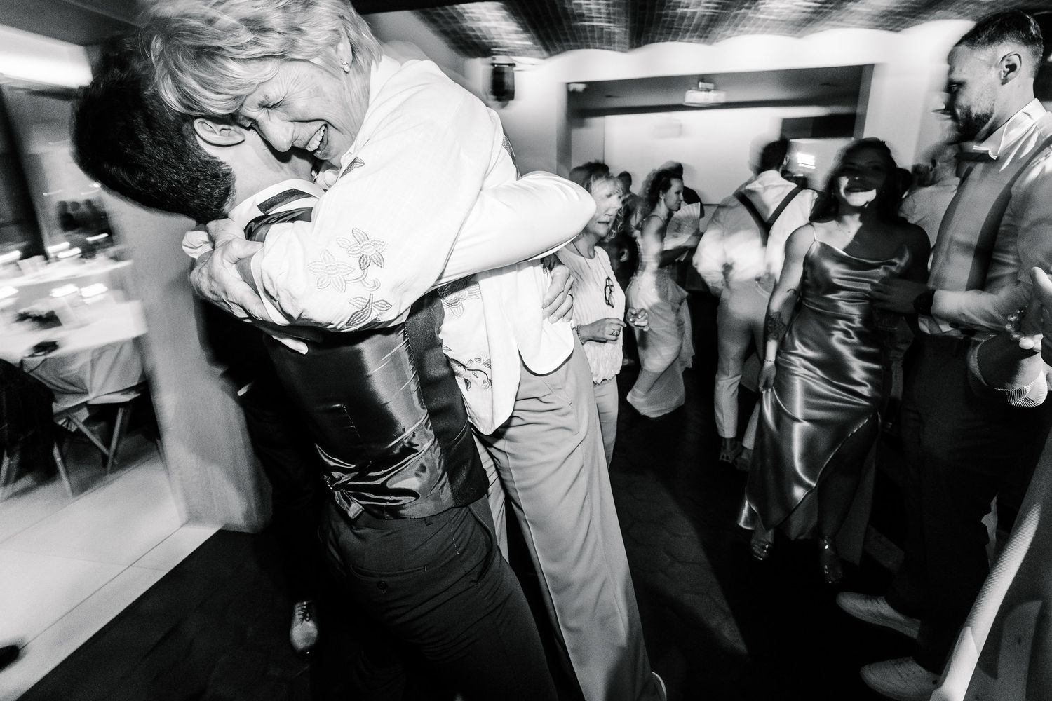 Black and white photo montage of people dancing and enjoying themselves at a lively party or nightclub event.