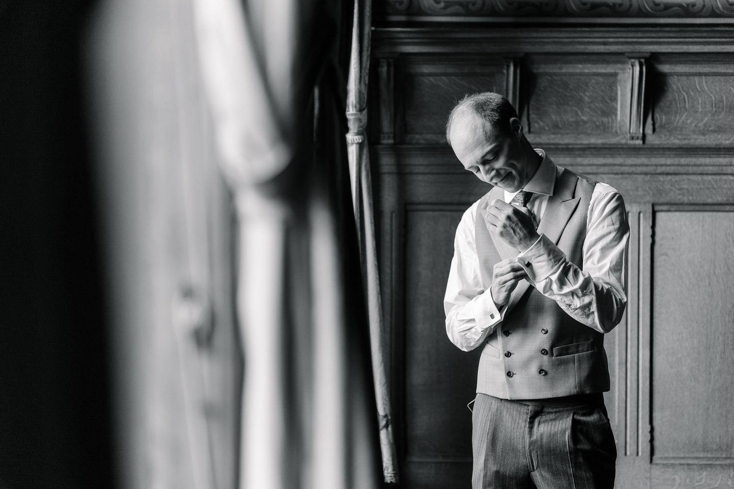 Black and white photos showing multiple angles of people in formal wear interacting inside a traditional church setting.