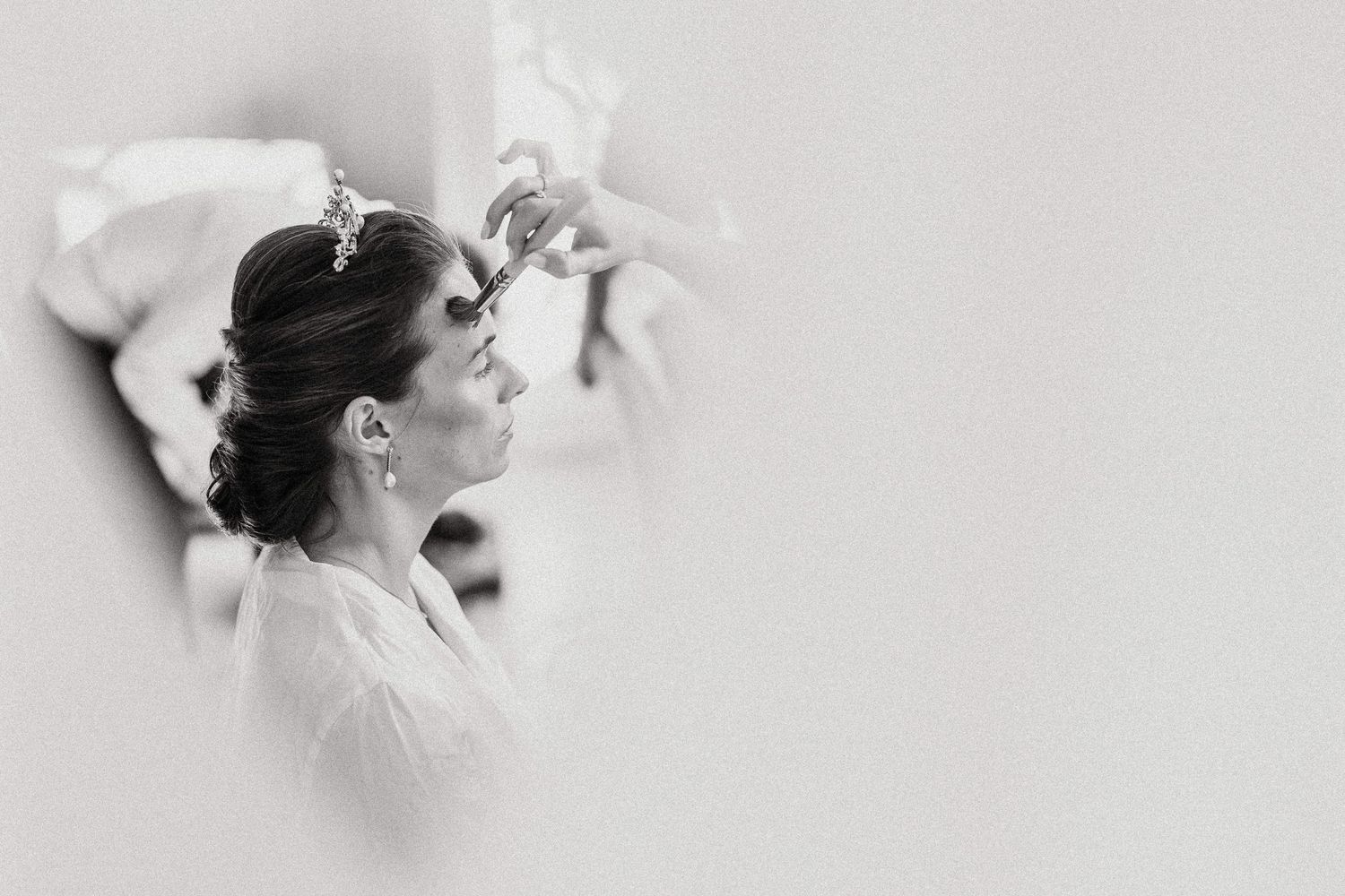 Four black and white artistic profile portraits of a woman with her hair up, shown in different angles and poses.