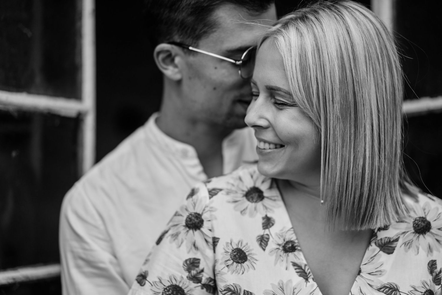 Black and white wedding photo collage showing romantic moments between newlyweds with sunflower bouquet details.