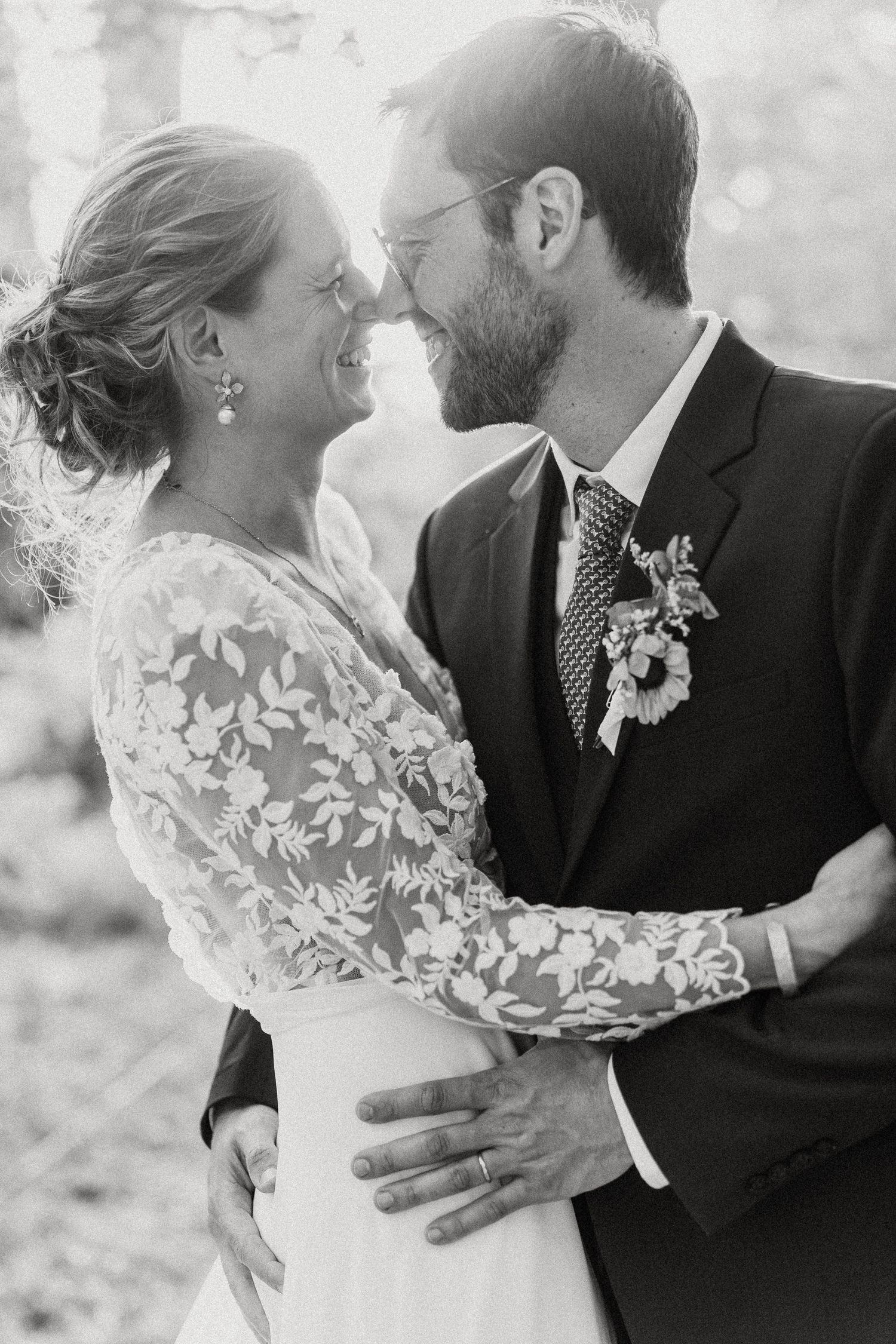 A romantic black and white wedding photo series showing intimate moments between newlyweds embracing outdoors.